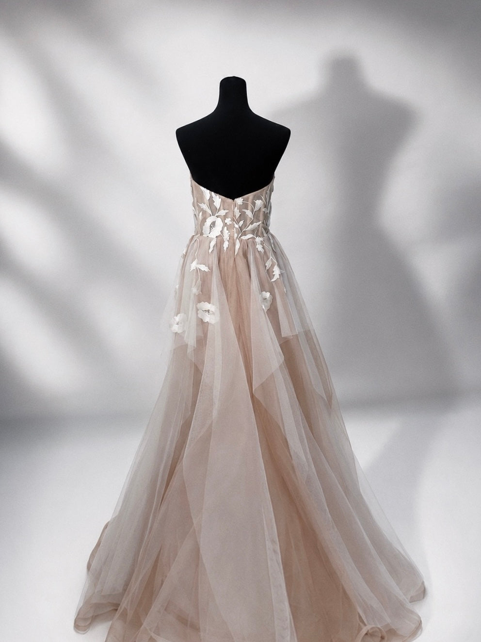 Back view of the Arrowyn ethereal wedding dress displayed on mannequin with illusion corset.