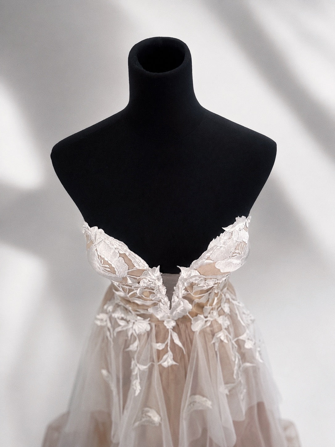 Details on the Arrowyn ethereal wedding dress displayed on mannequin with illusion corset.