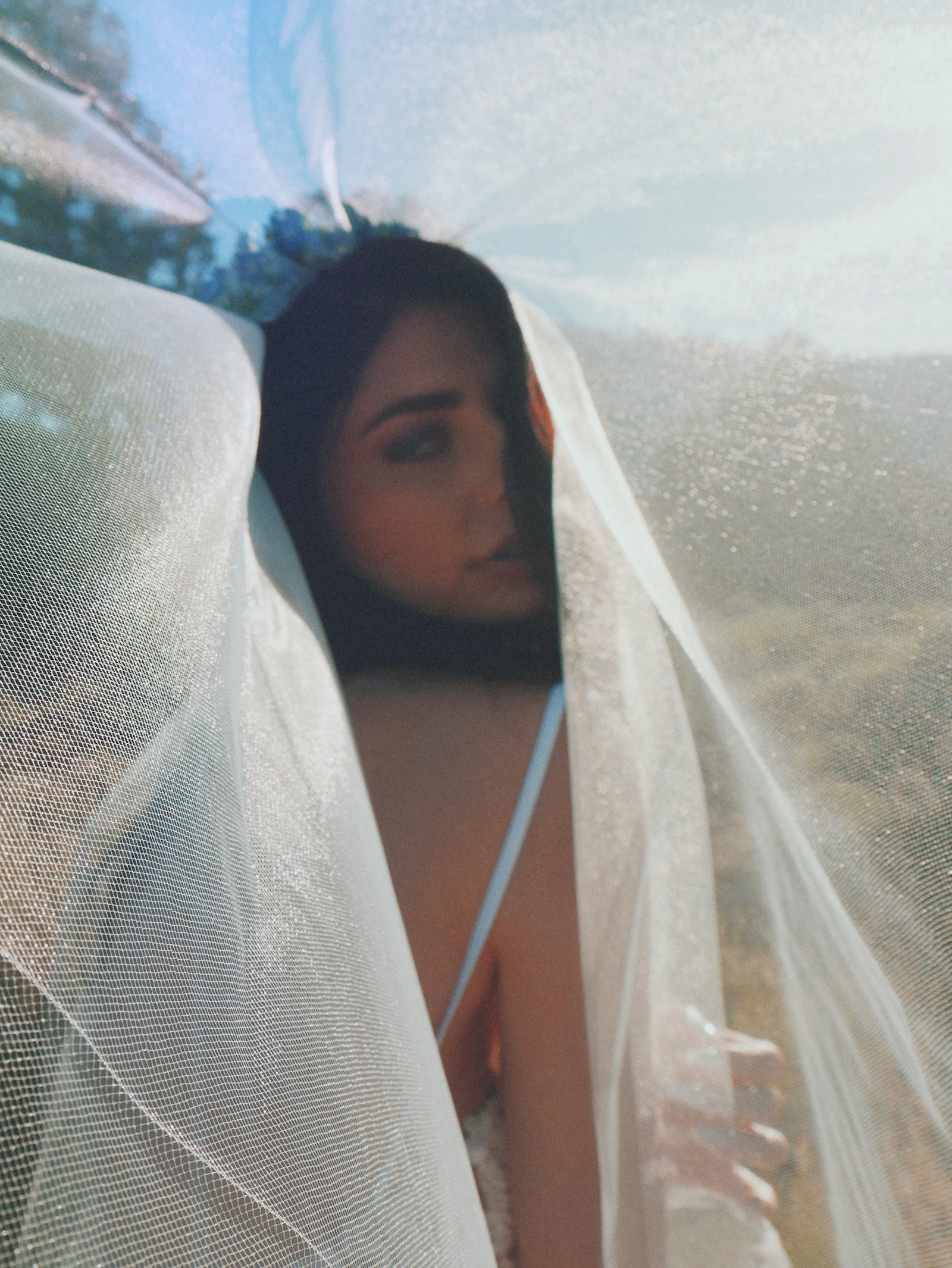 Editorial fashion campaign image of a model wearing a tulle blusher wedding veil by Lauren Elaine