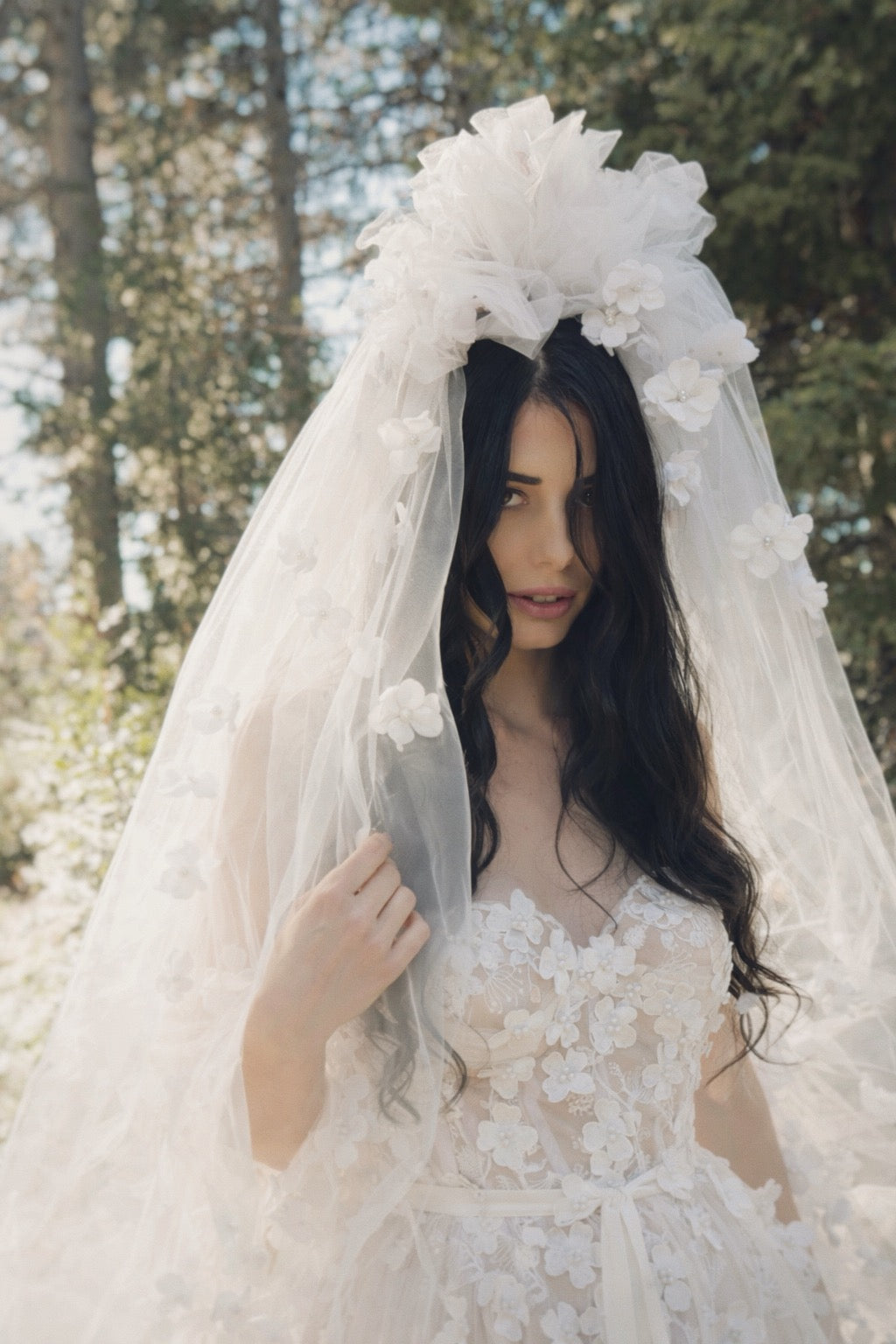 Romantic white floral bridal veil with soft tulle and sculptural flowers