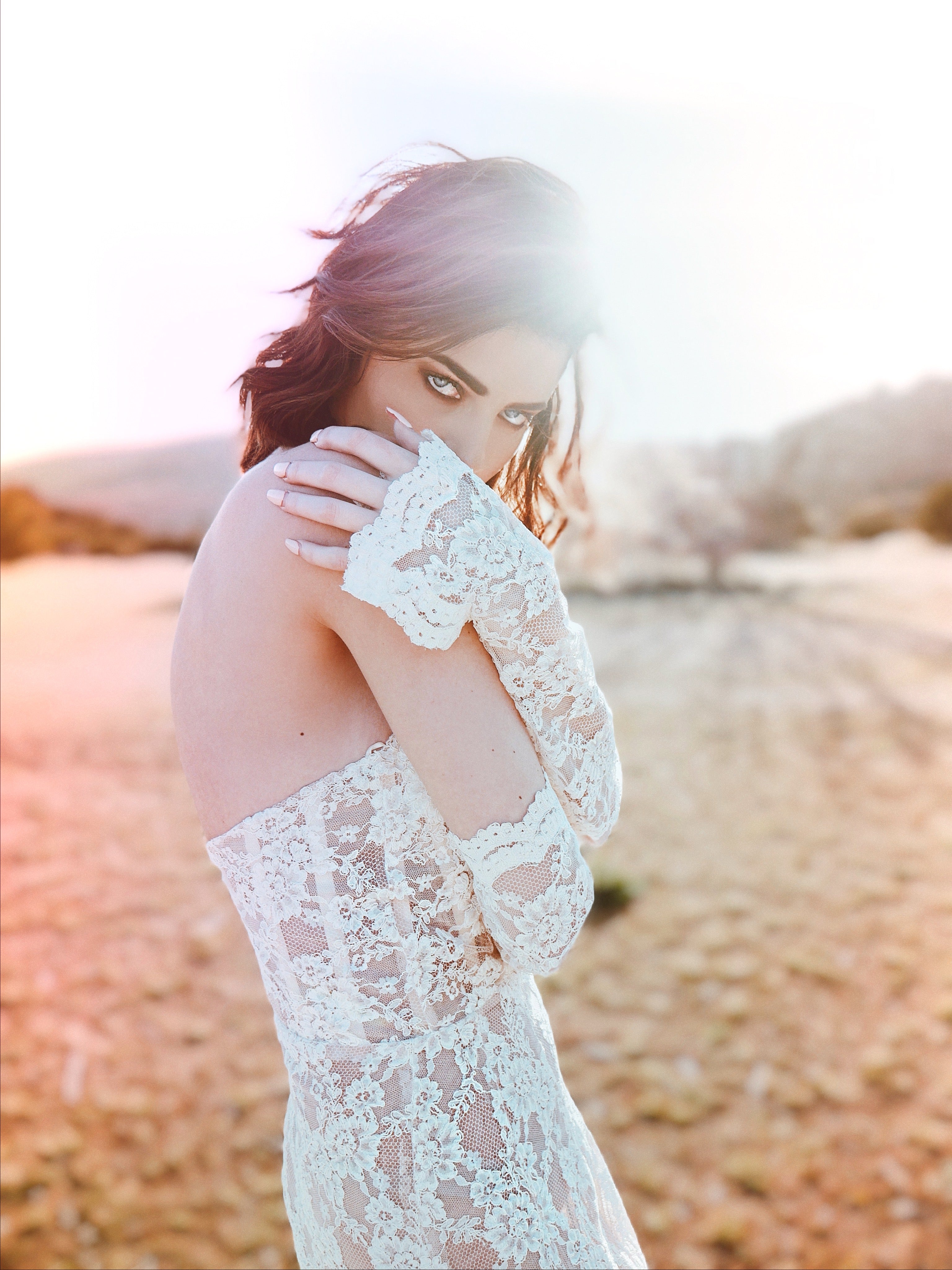 Close-up of detachable lace bridal sleeves showing floral scalloped lace pattern