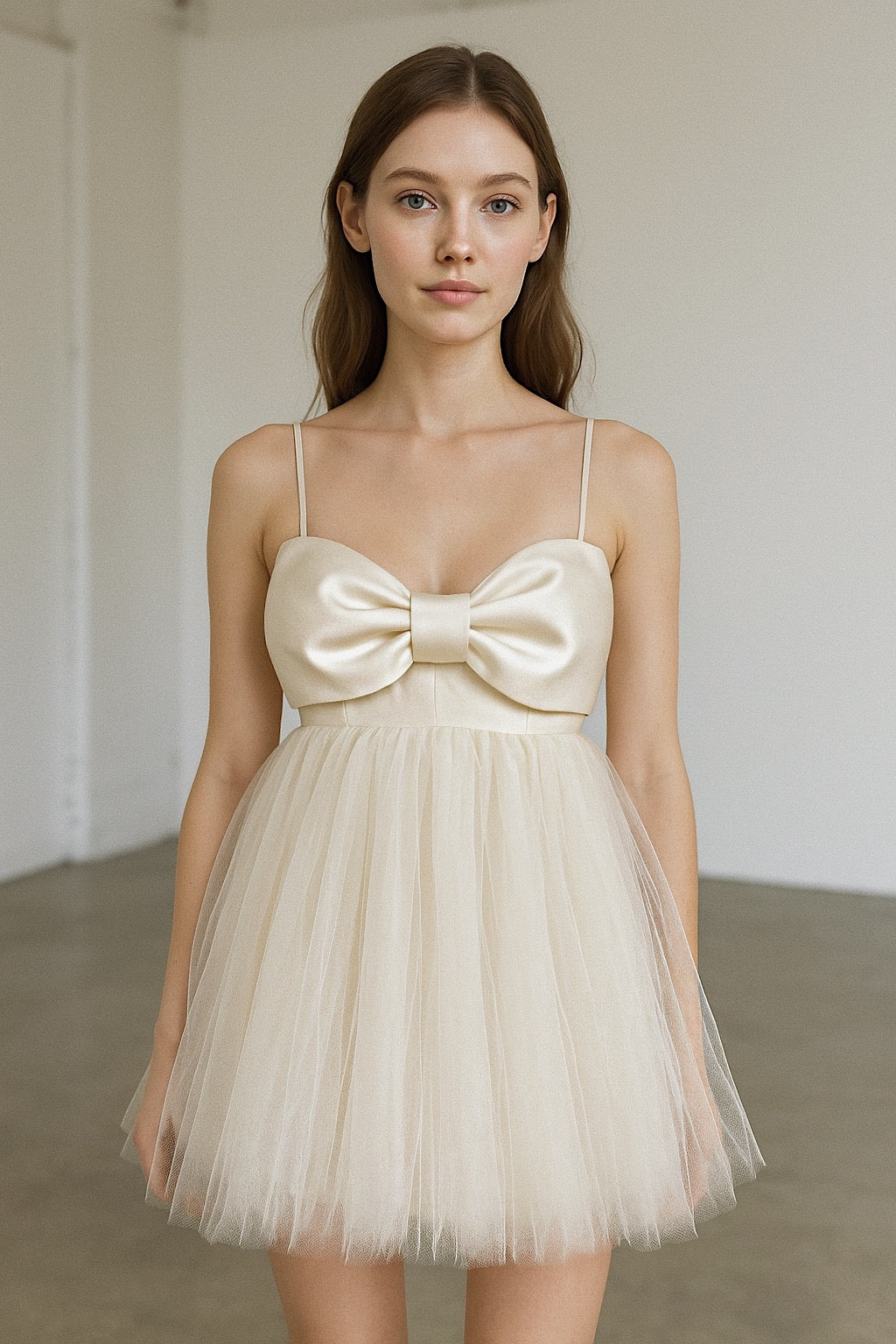 Dolly mini wedding dress featuring empire waistline, satin oversized bow, and tulle skirt