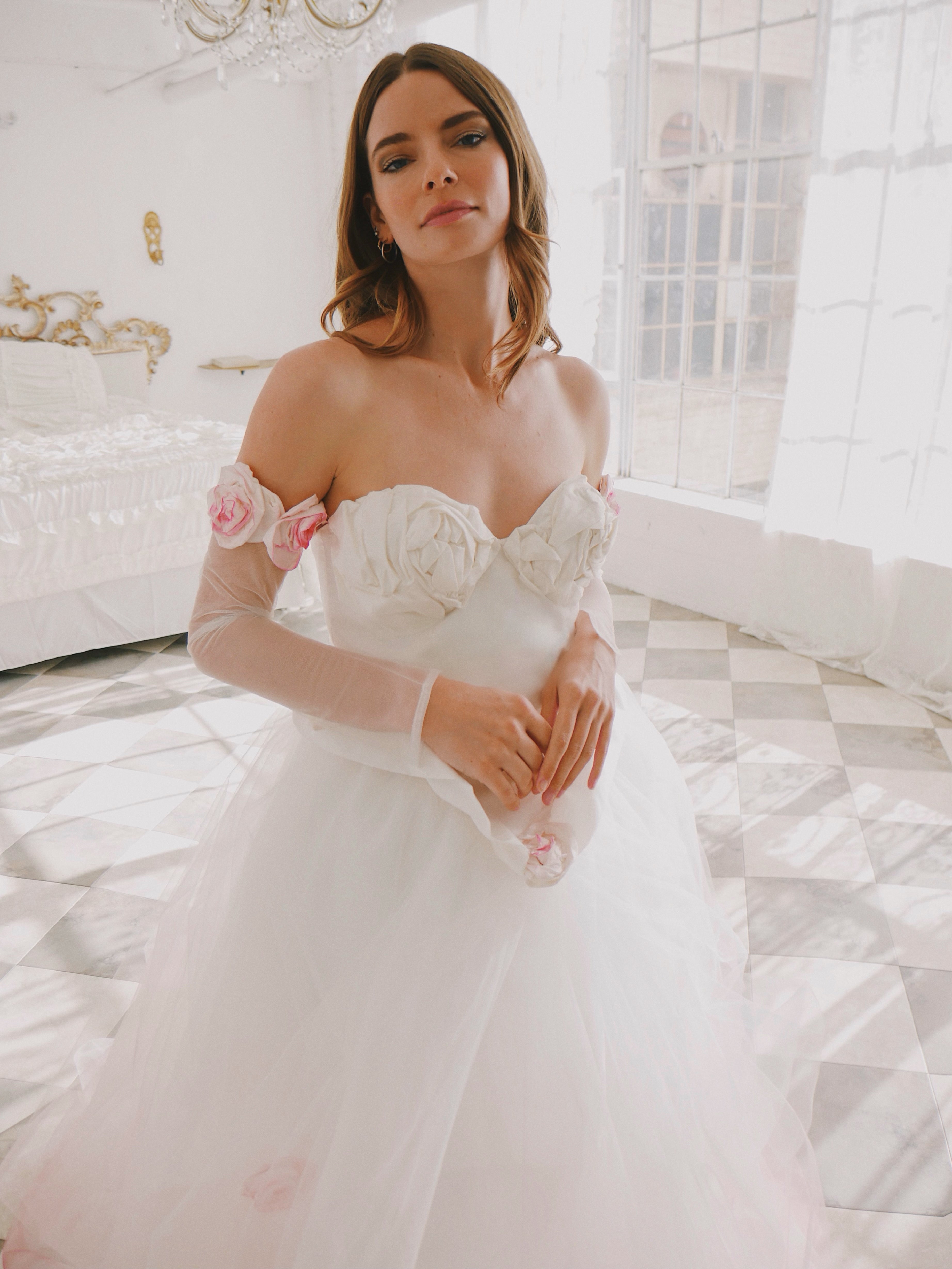 Close up of corset pink wedding dress with rosettes on bodice