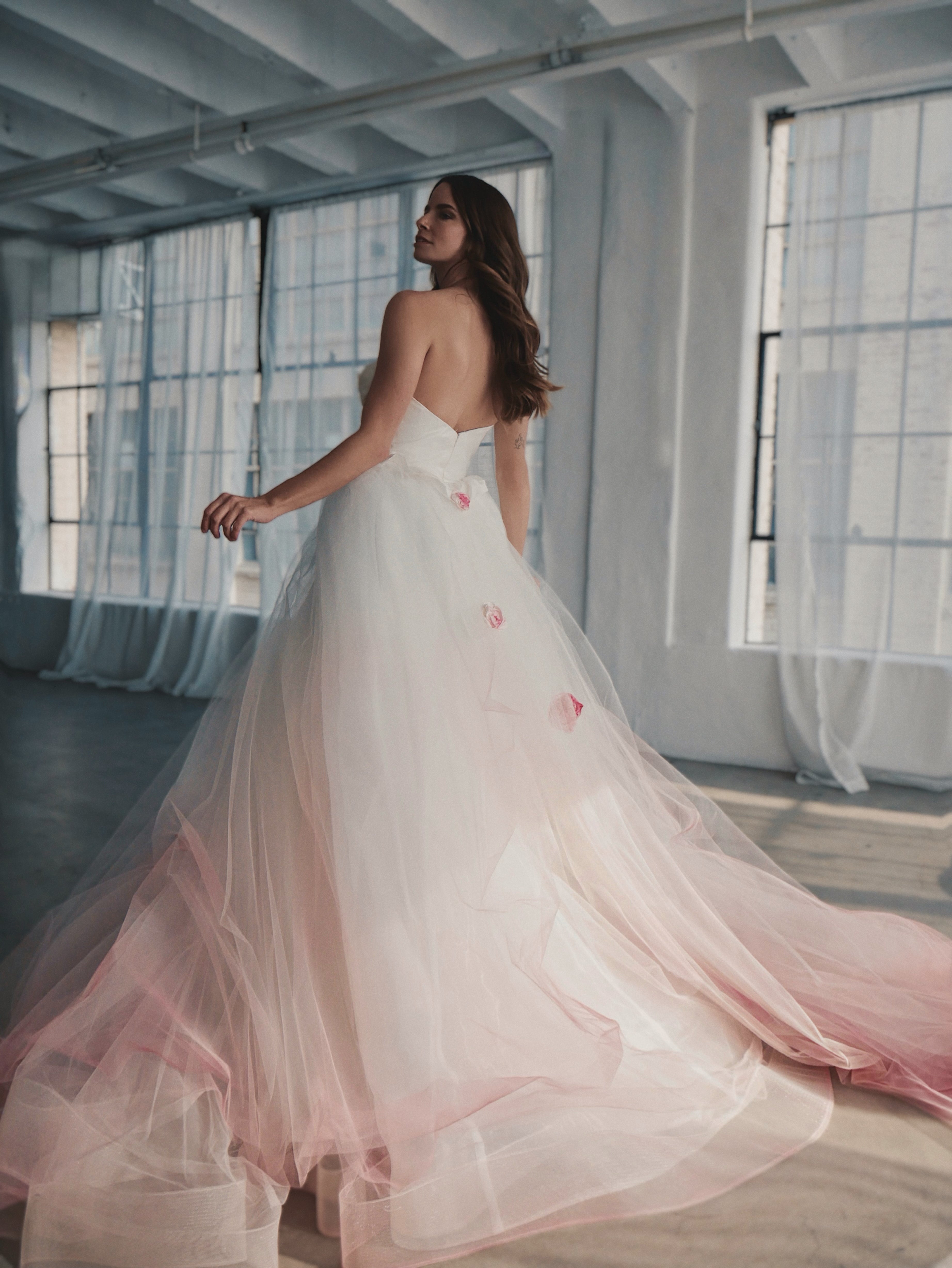 Shot from behind of layered tulle in blush ombre wedding dress