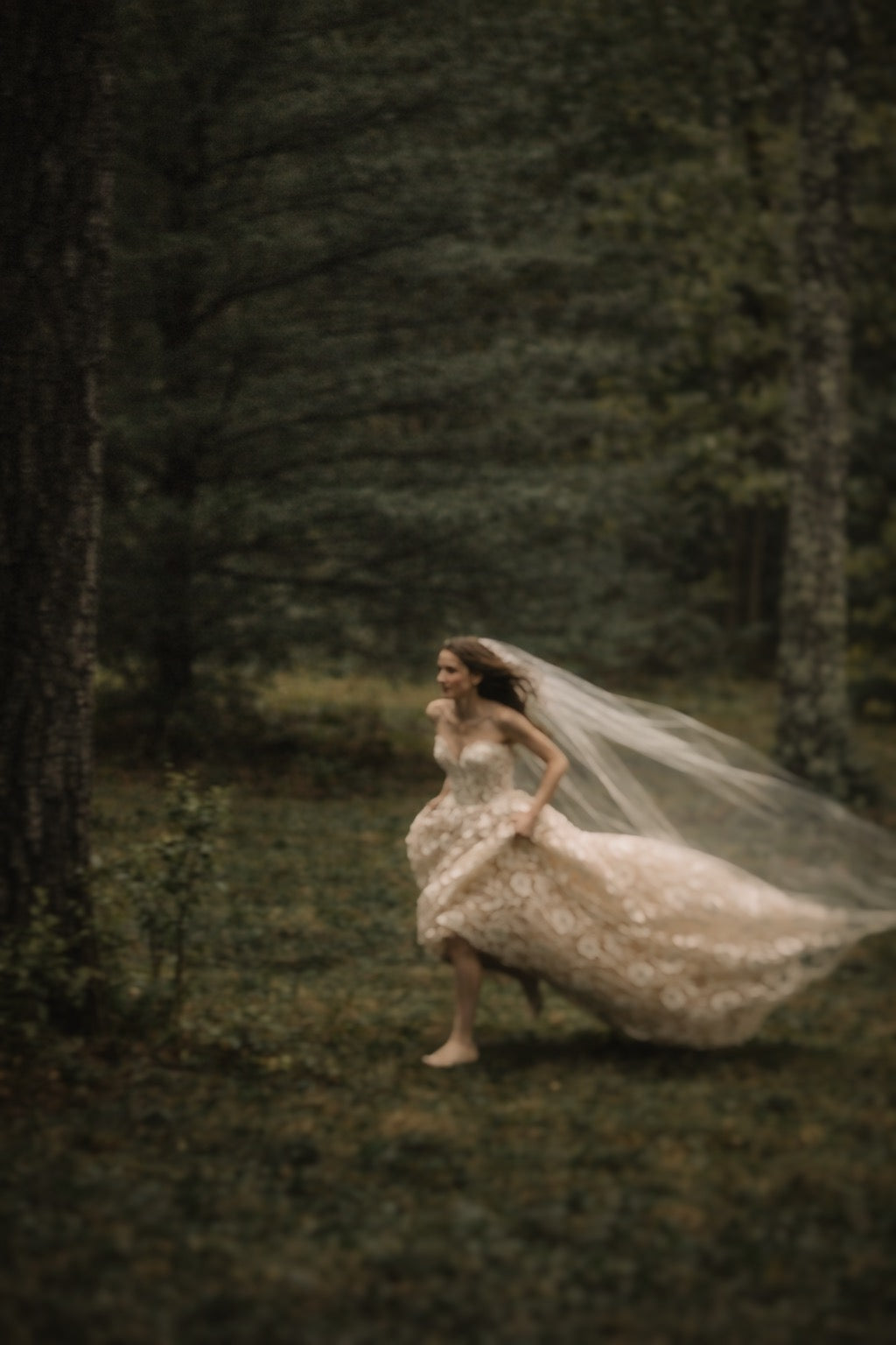 Elowen romantic couture wedding gown running through forest, floral lace wedding dress with train