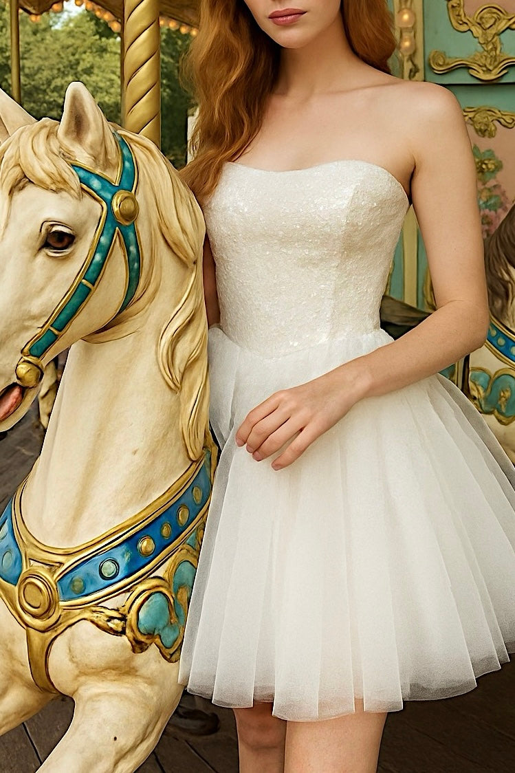 Close-up of Étoile bridal mini gown with sequin bodice and tulle skirt beside carousel horse.