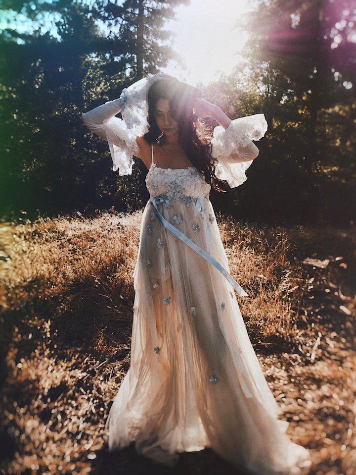 Full-length Florêve wildflower wedding dress with blue floral appliqués and detachable sheer floral sleeves