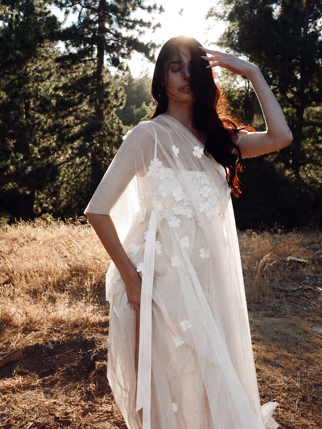 Florêve white floral wedding dress with 3D wildflower appliqués and sheer layered illusion net