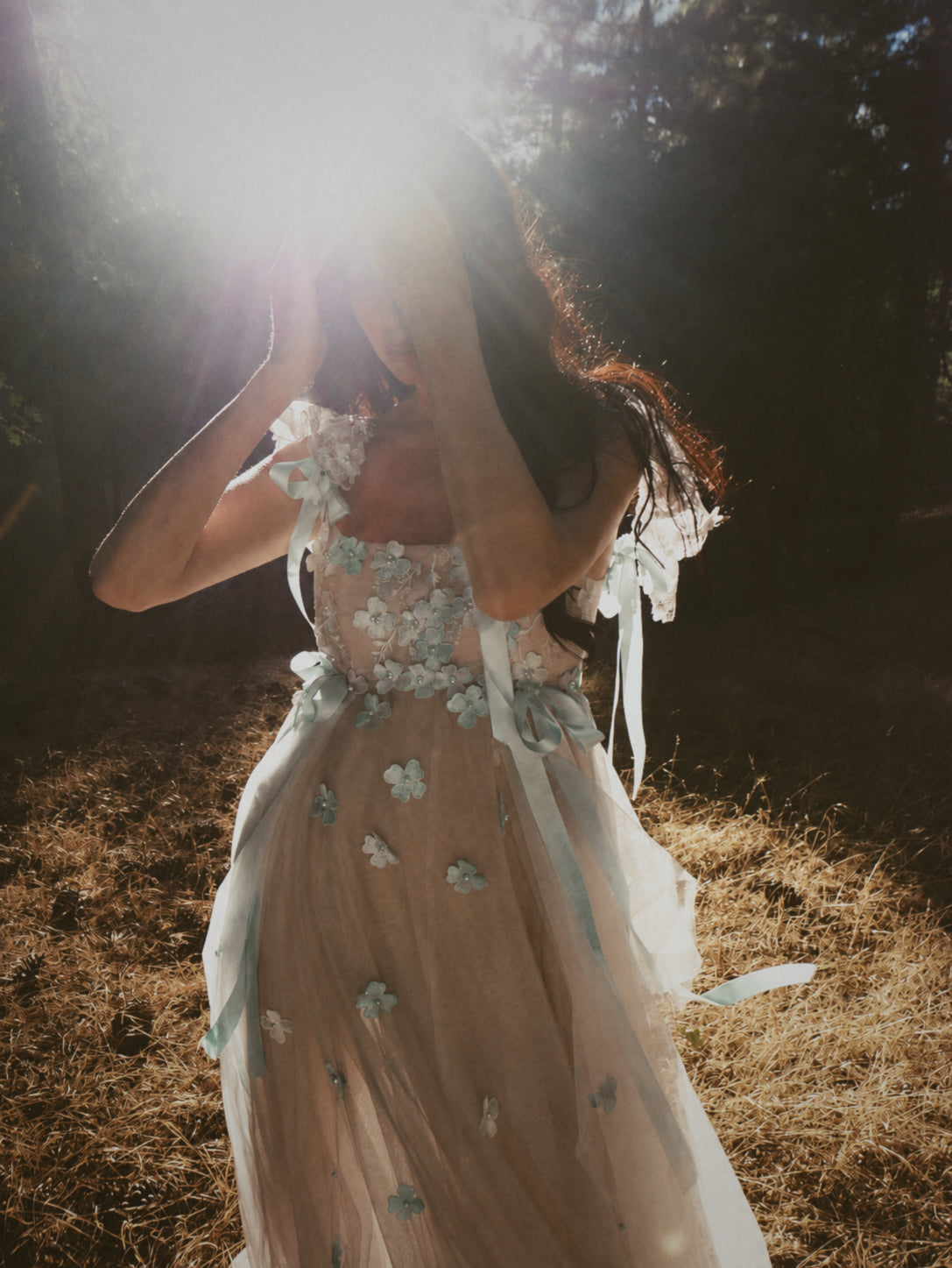 Florêve seafoam and sage wildflower wedding dress with hand-painted floral appliqués, ribbons and sheer blush tulle