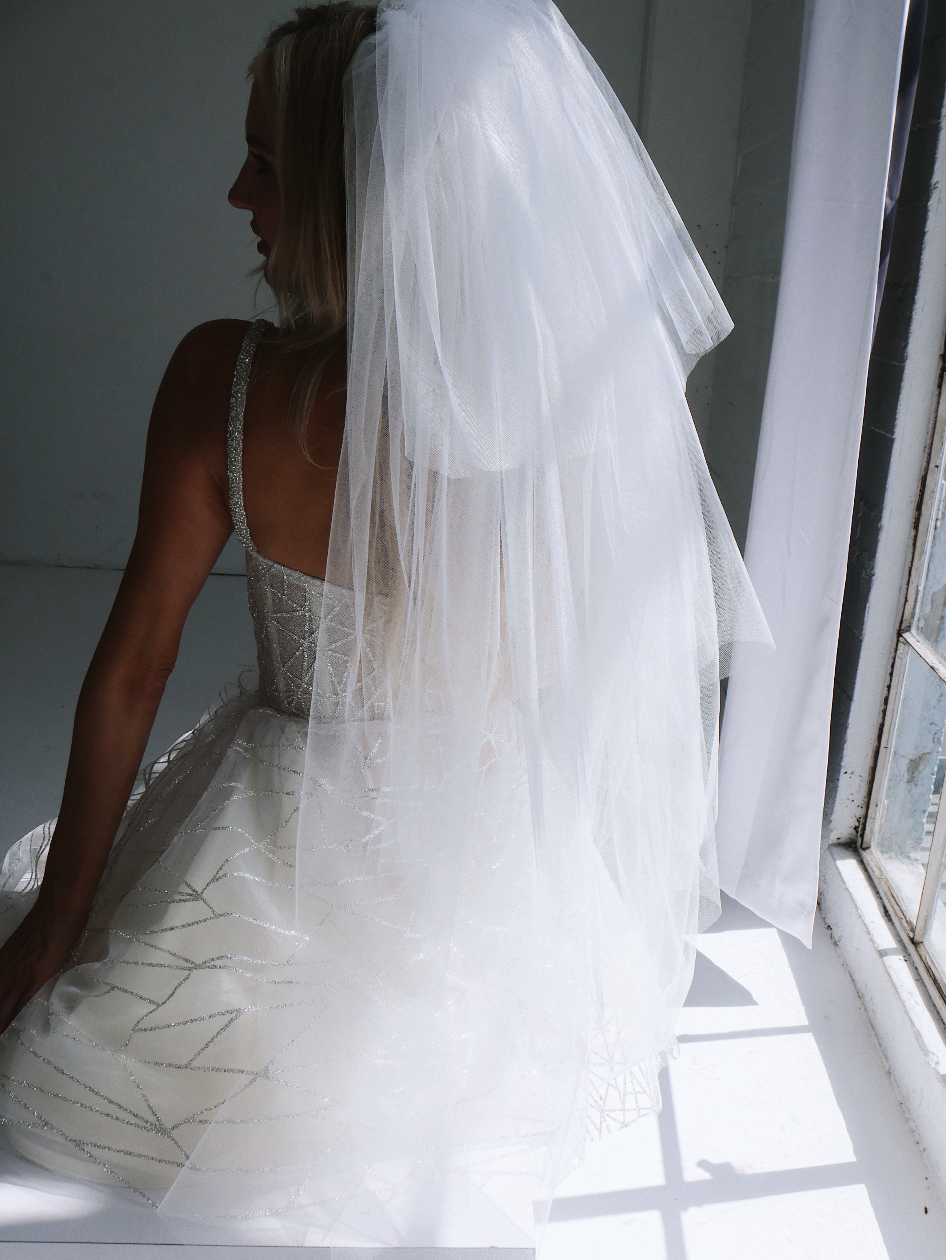 Back view of the Lauren Elaine Mirrorball Mini Wedding Dress with glam Rock tiered bridal veil.
