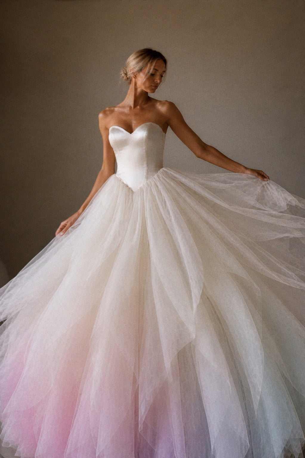 Opaline rainbow ombre wedding dress with flowing tulle skirt and hand-painted pastel color gradient