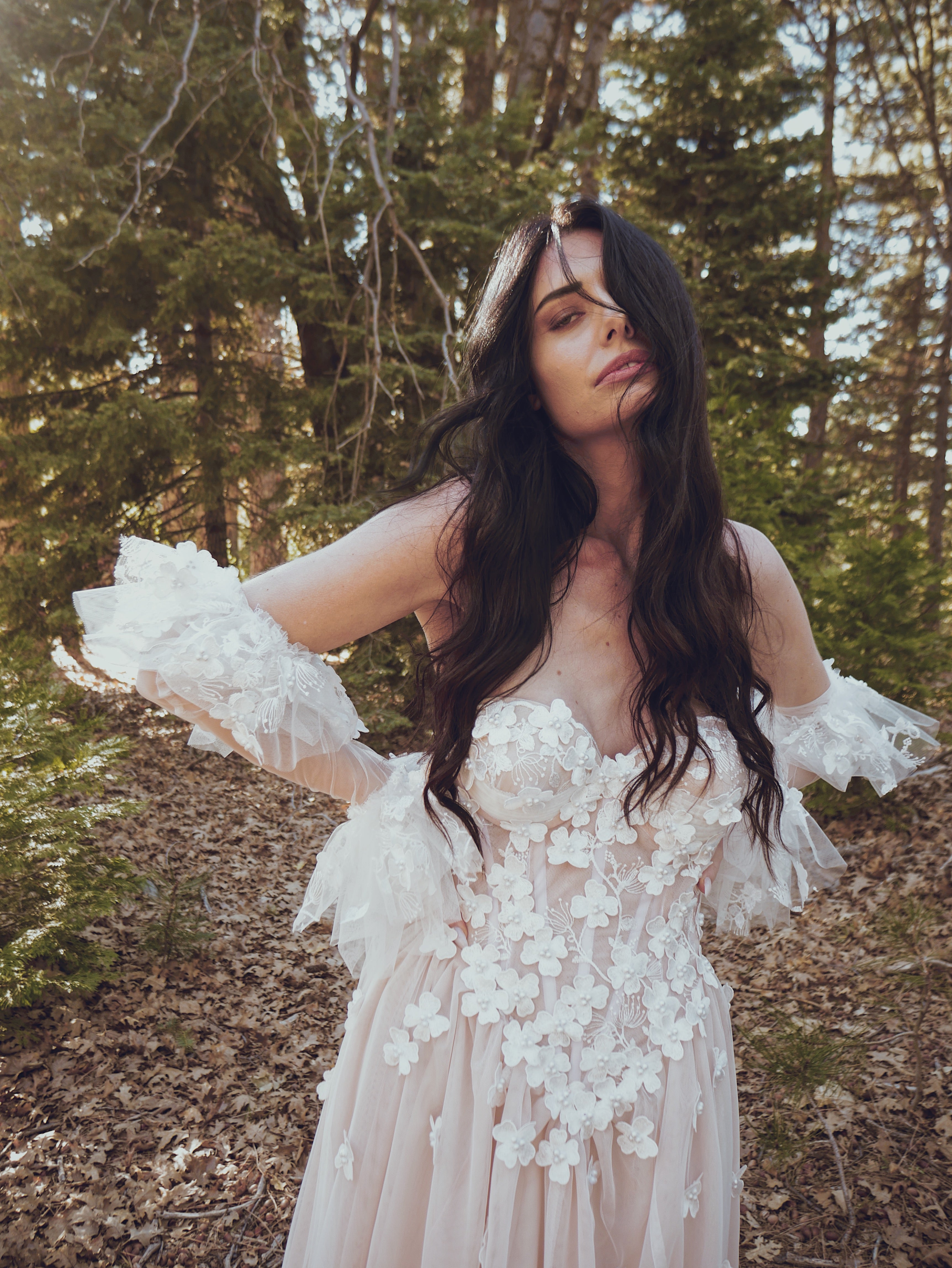 Valen ethereal floral wedding dress by Lauren Elaine featuring a 3D floral corset bodice, sheer illusion neckline, and romantic bohemian bridal styling