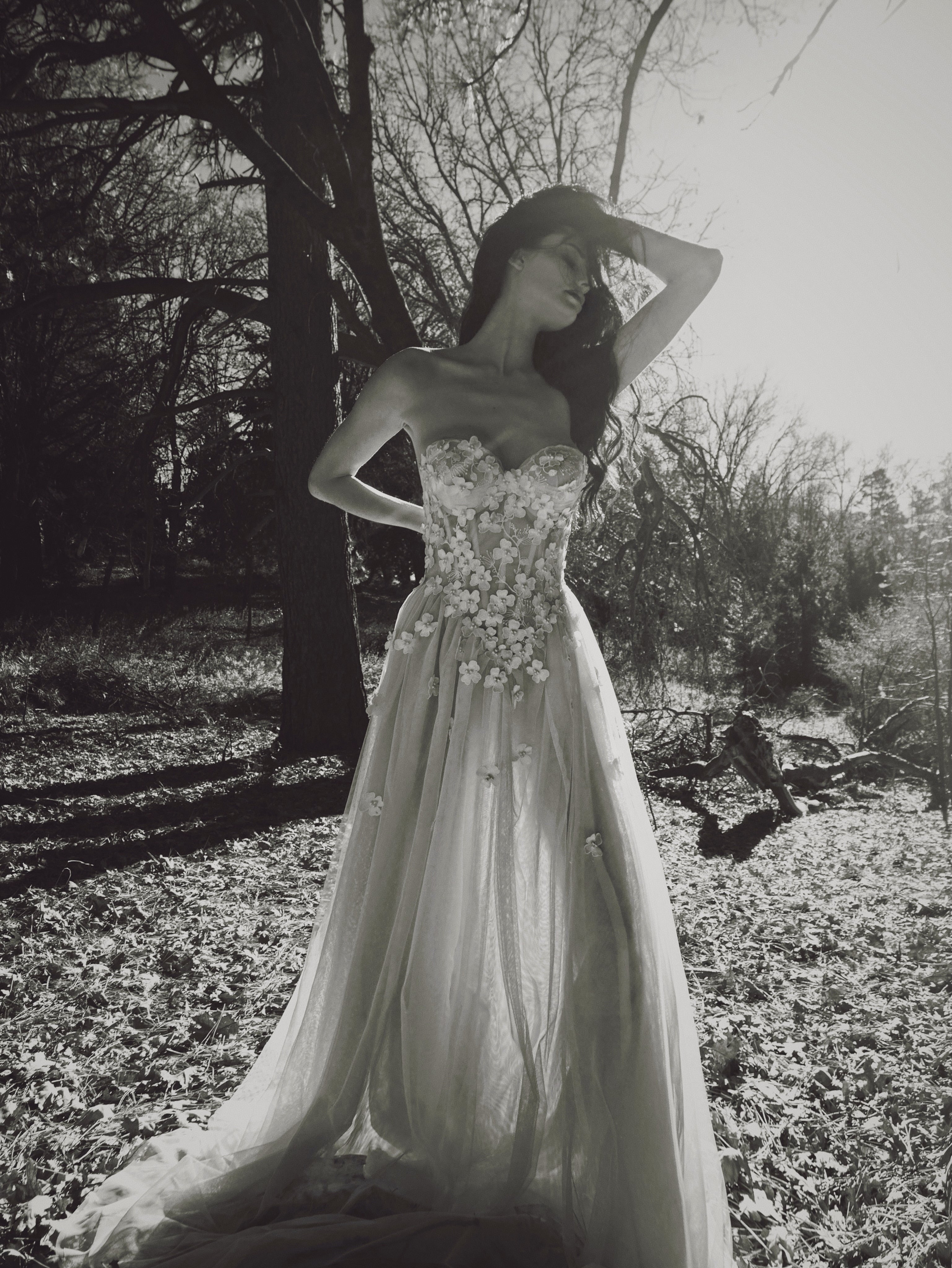 Valen couture A-line wedding dress featuring floral lace appliqués, exposed corset bodice, and flowing ethereal tulle skirt