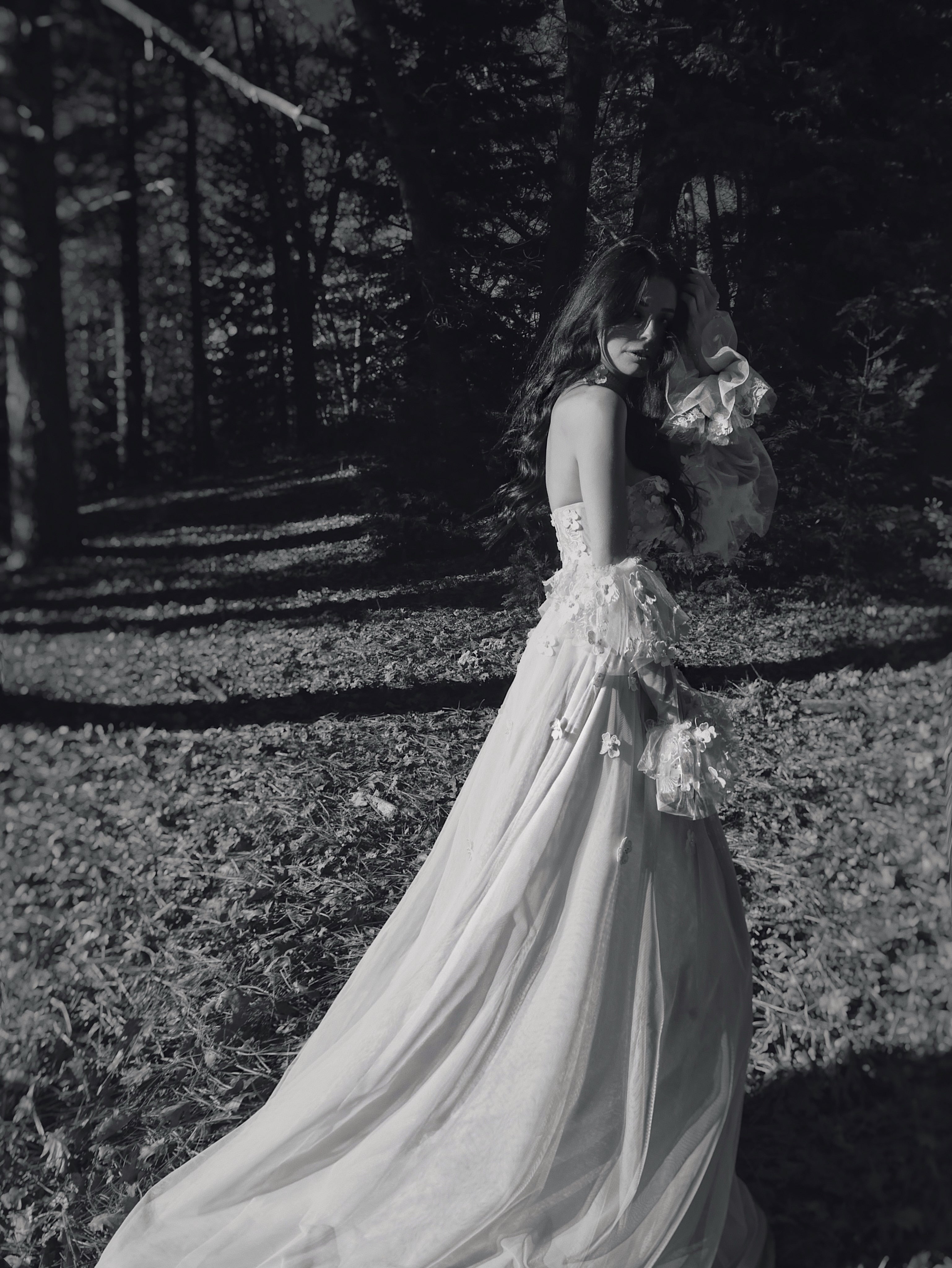 Valen floral wedding dress featuring a basque waist, illusion corset construction, and romantic woodland bridal styling