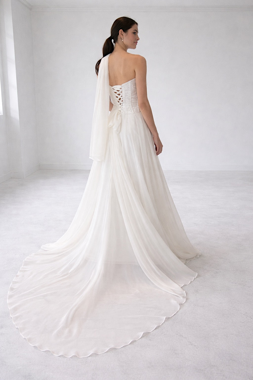 Cadence basque waist corset wedding dress with flowing chiffon skirt and back bow detail by Lauren Elaine Bridal
