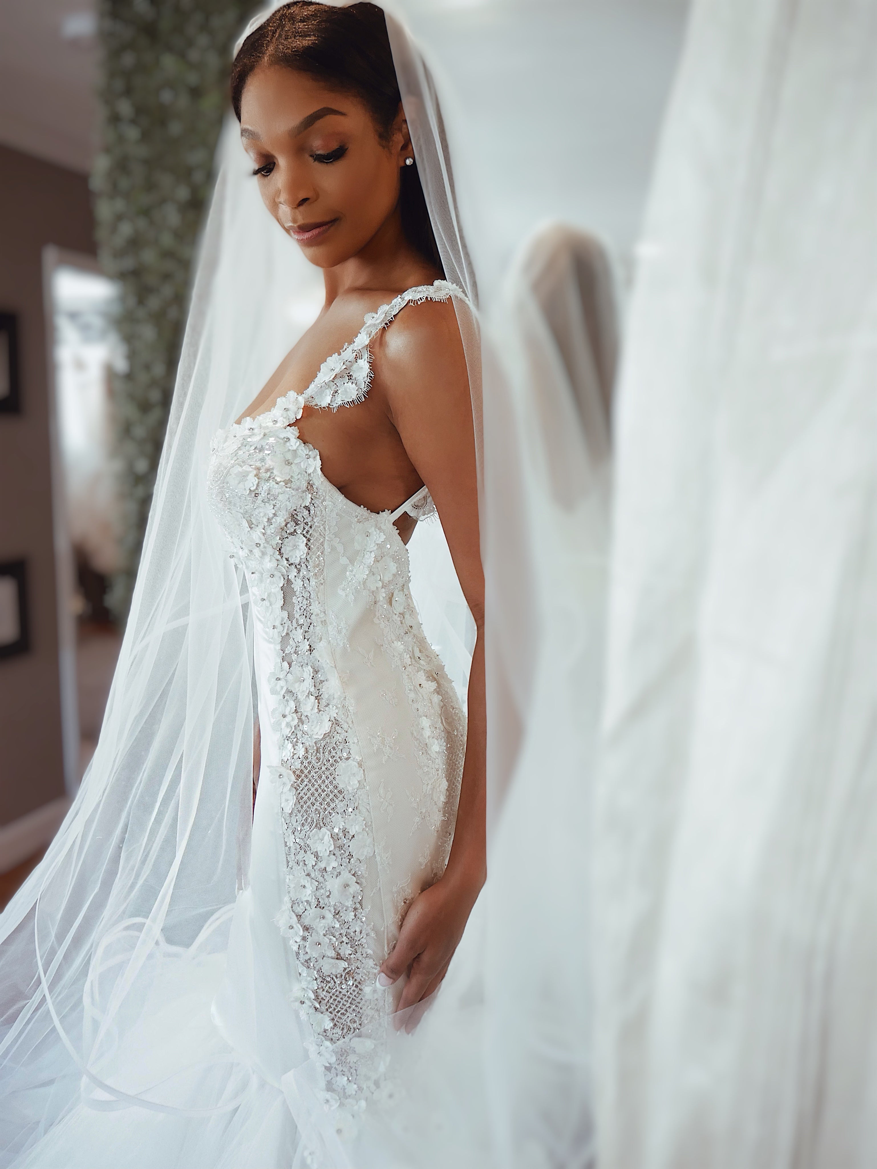 Bride in lace mermaid wedding gown with veil during private bridal appointment in Los Angeles
