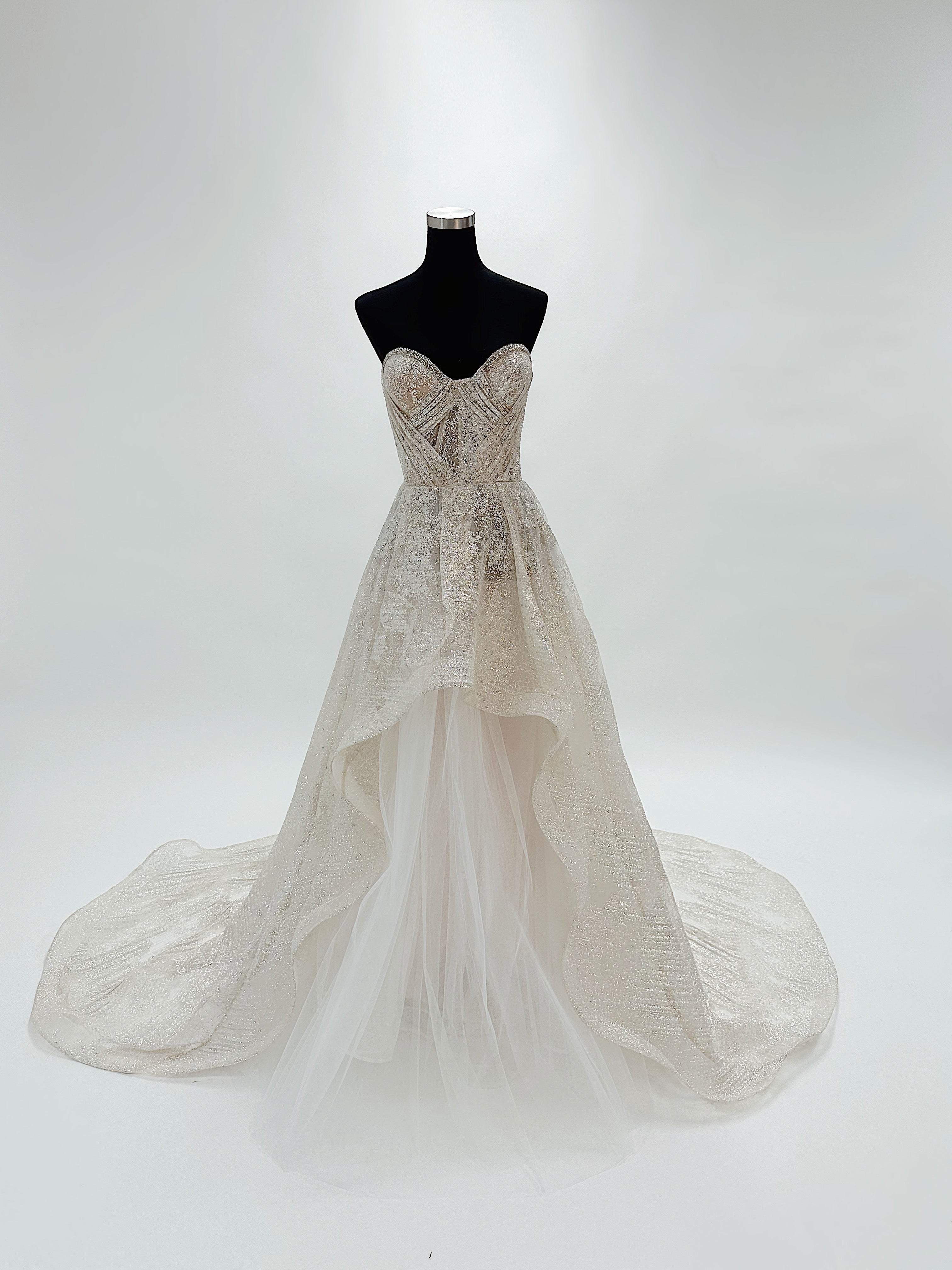 High-low couture wedding dress on mannequin in Los Angeles private bridal studio