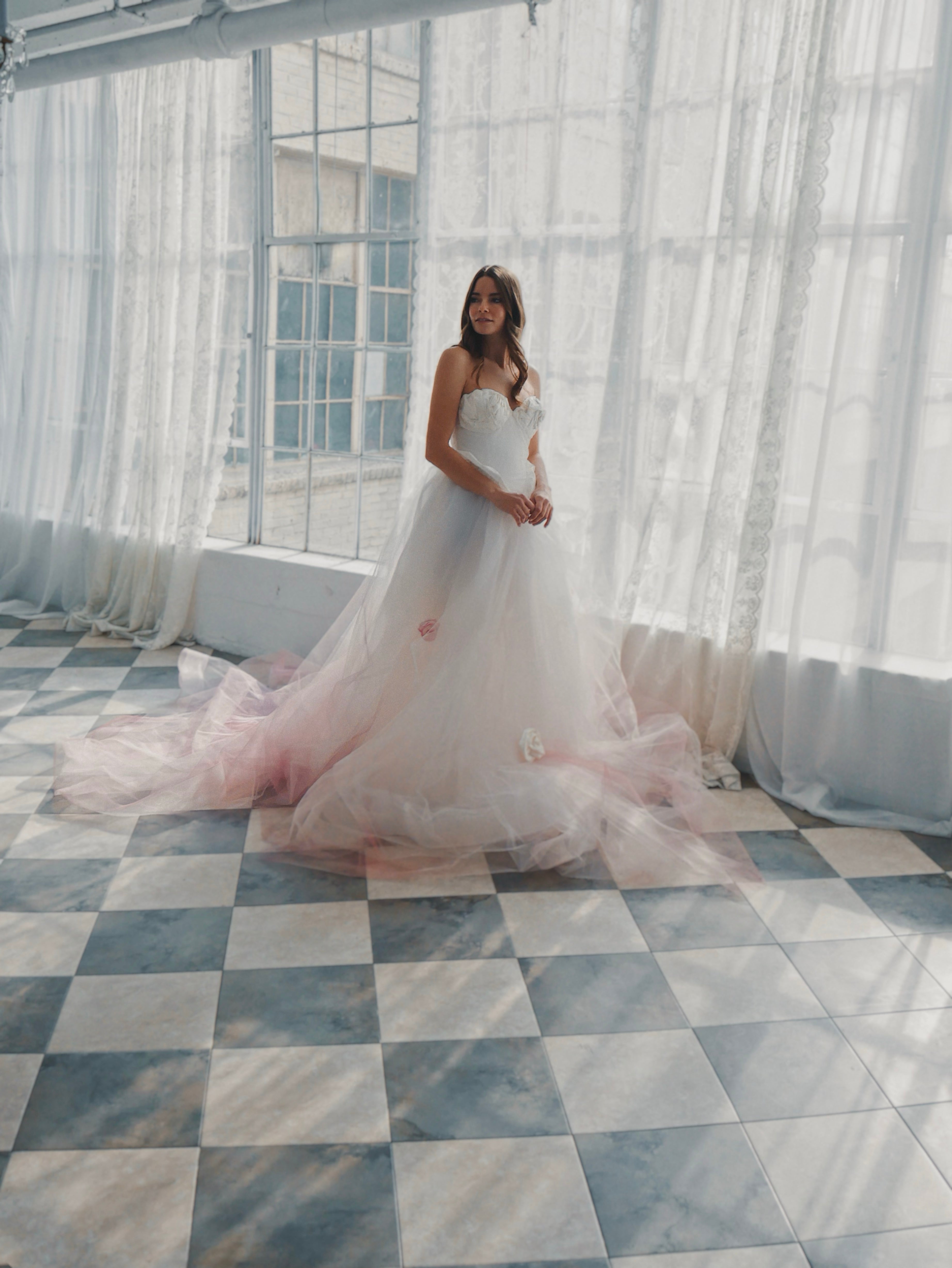 Alice in Wonderland inspired blush ombre wedding dress with Basque waist and rosettes.