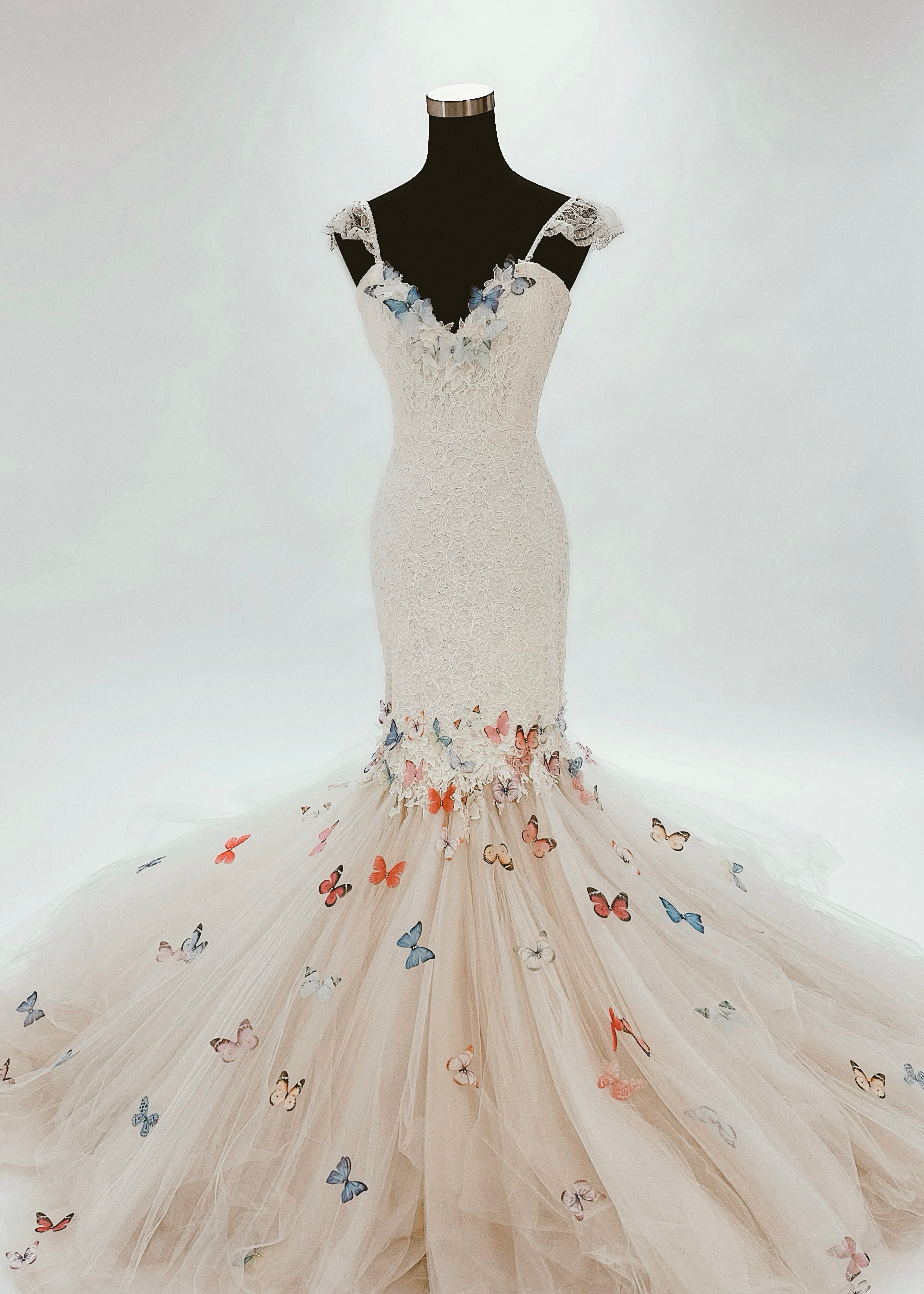 Mermaid wedding dress covered in rainbow butterfly 3D appliques and crystal detailing.