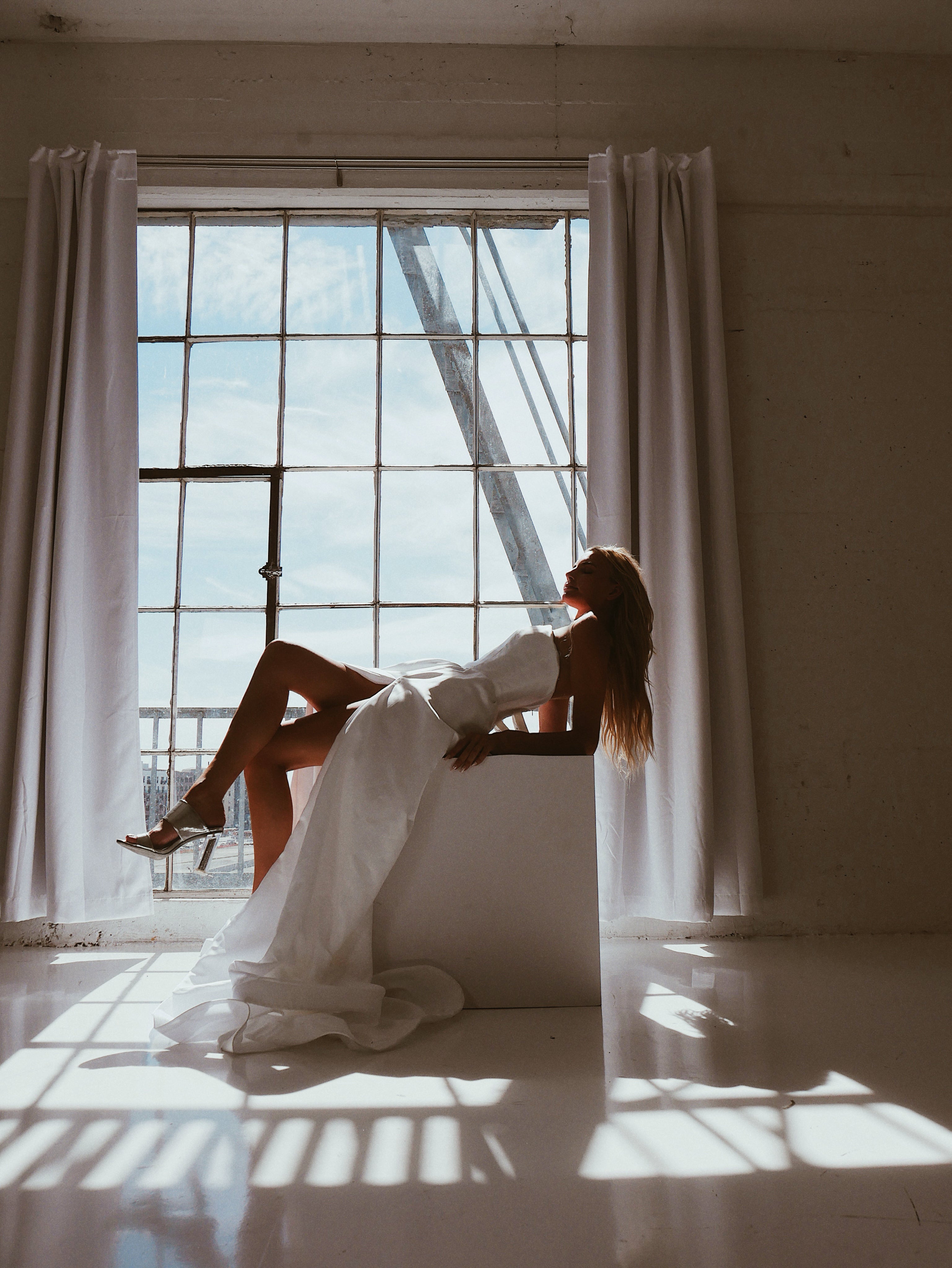 A model poses in a Corset Basque Waist Wedding Dress with Slit