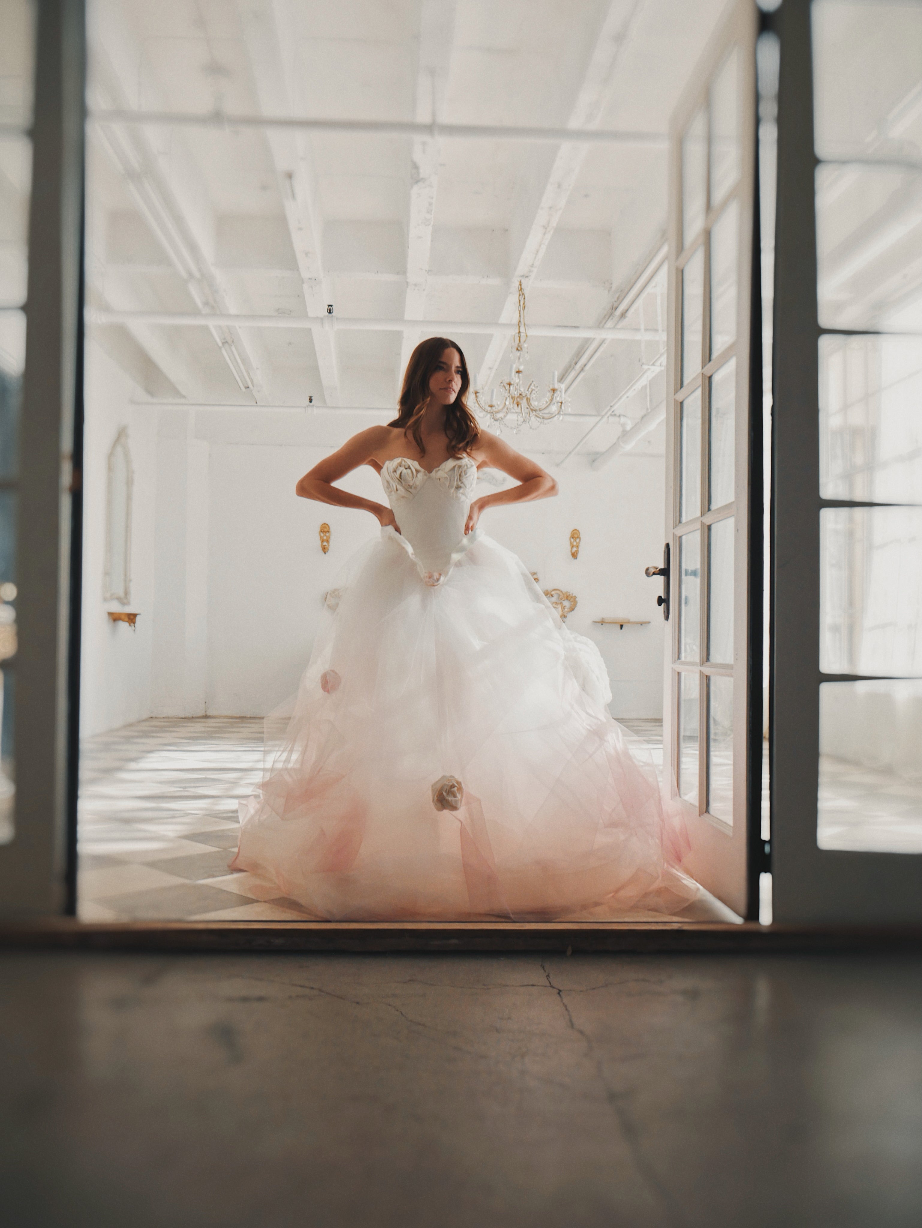 Full length image of model wearing the "Duchess" Blush Basque Waist Corset Wedding Dress with Roses