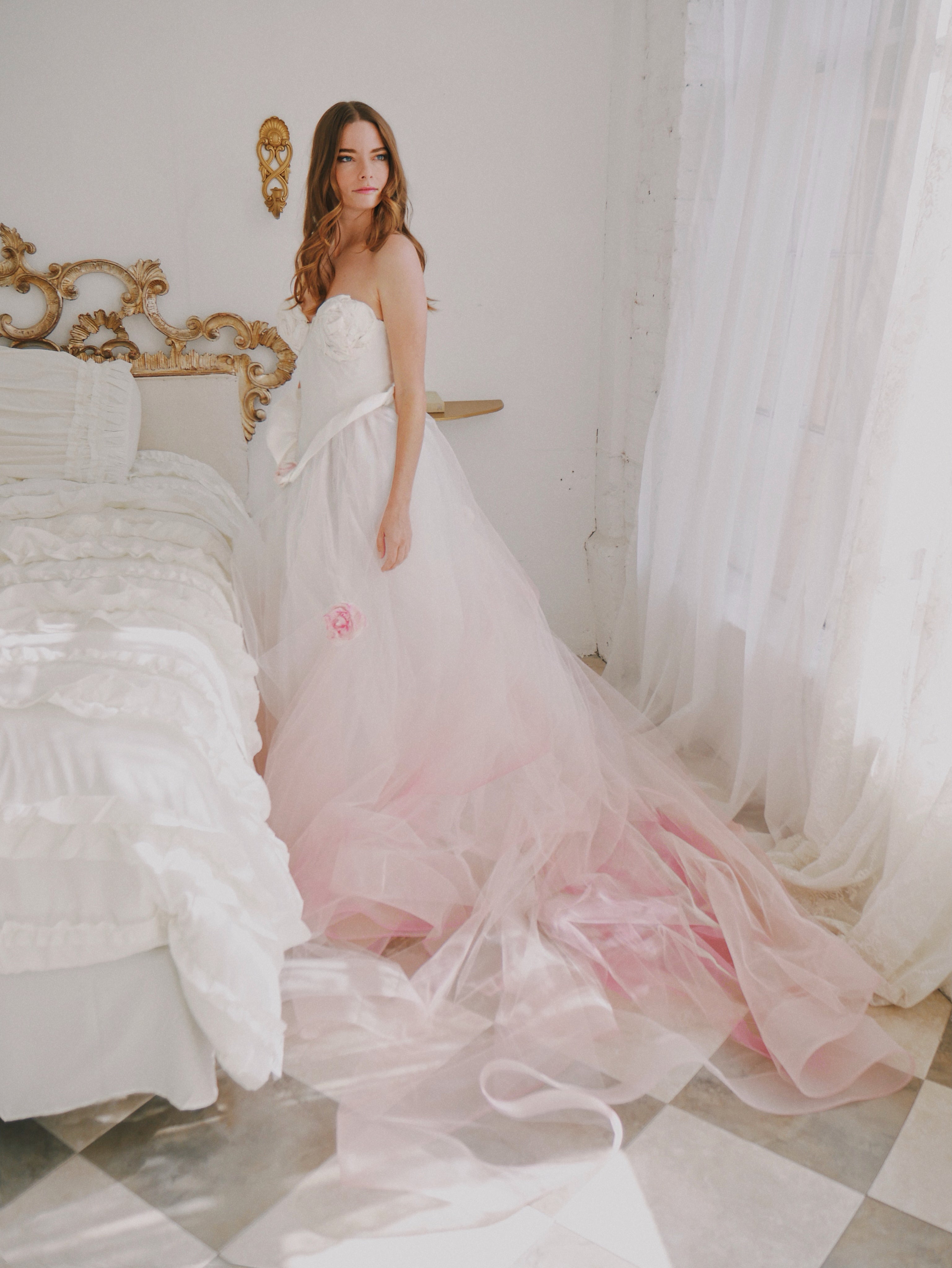 Bridgerton wedding dress standing next to Victorian bed