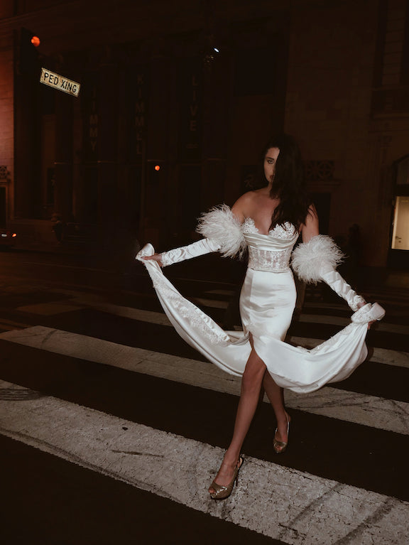 A model stops traffic on Hollywood Blvd in a Lauren Elaine Encore Corset Satin Trumpet Bridal Gown 
