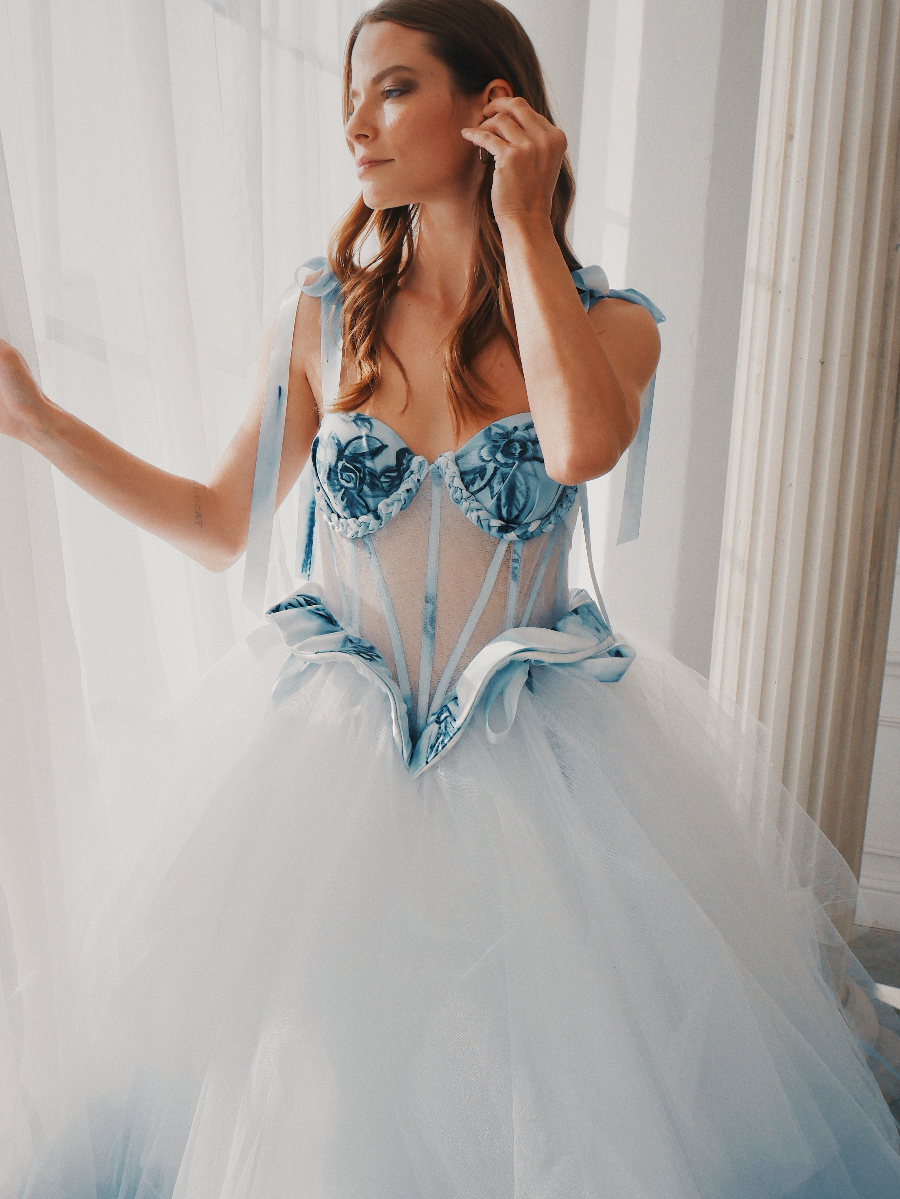 Detail image of a Basque waist illusion corset wedding dress with watercolor Prussian blue florals.
