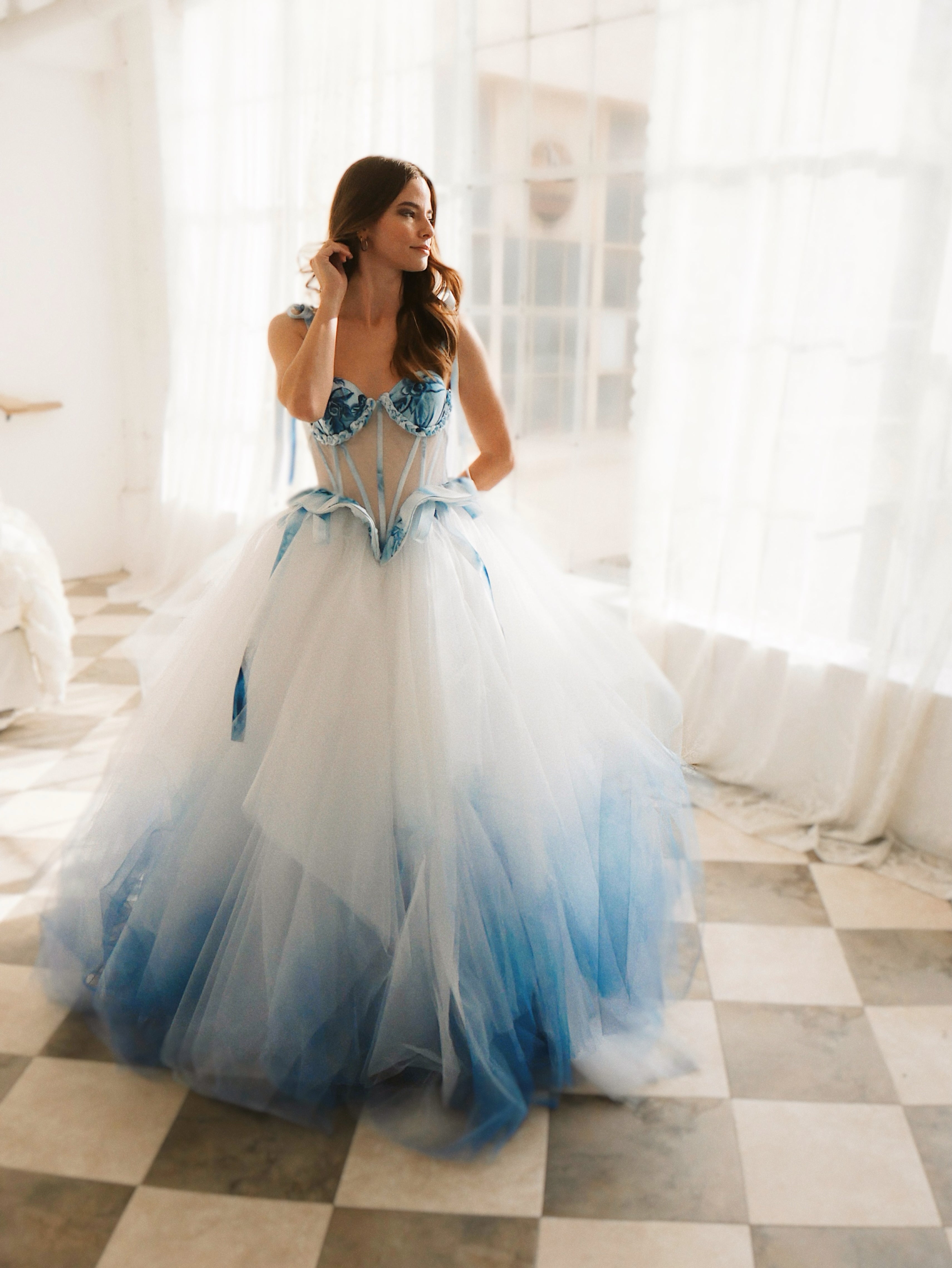 Alice in Wonderland inspired blue wedding dress with Basque waistline and with watercolor details.