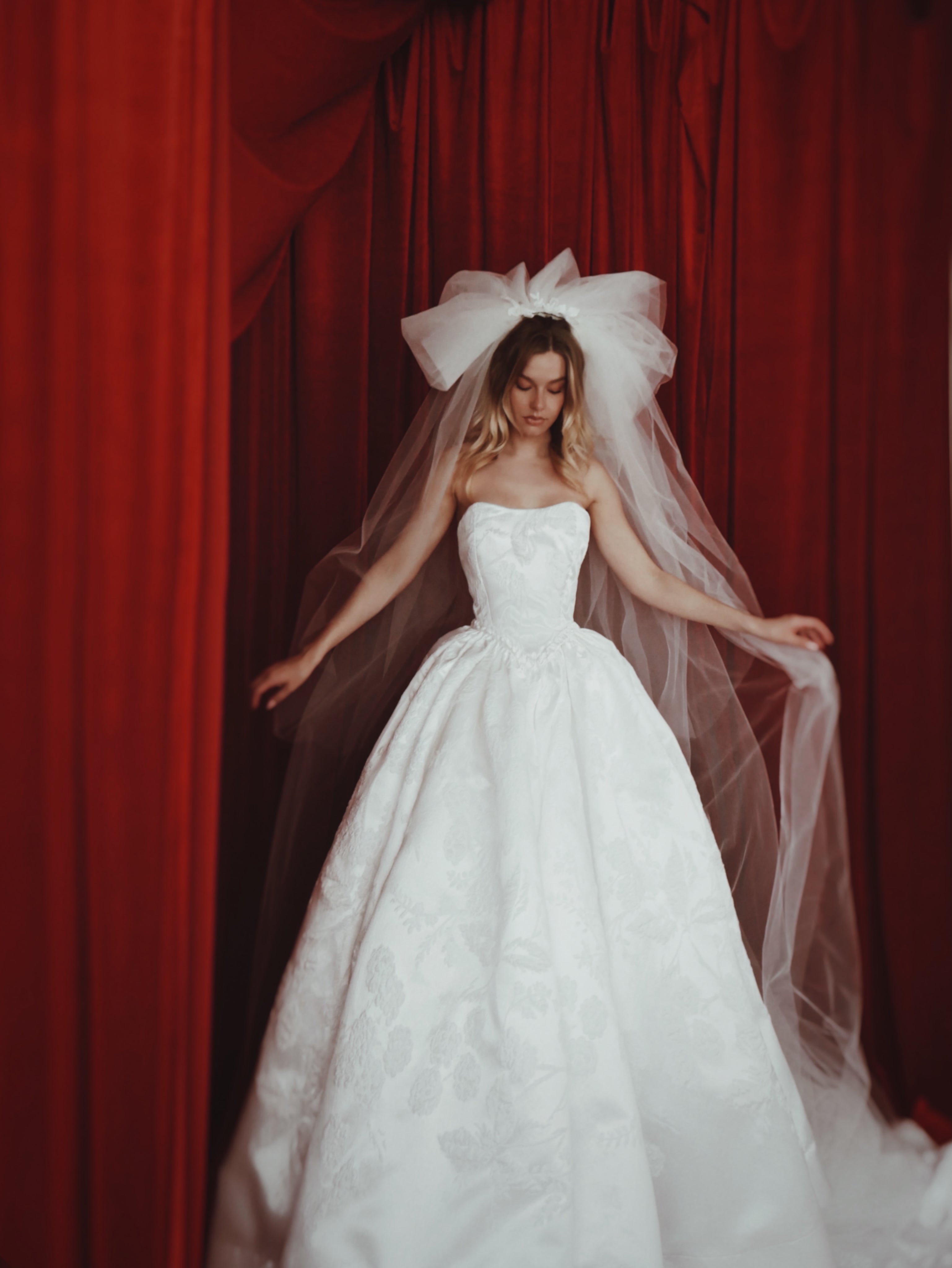 A model poses in the dramatic "Opus" 1980s inspired pouf wedding veil.