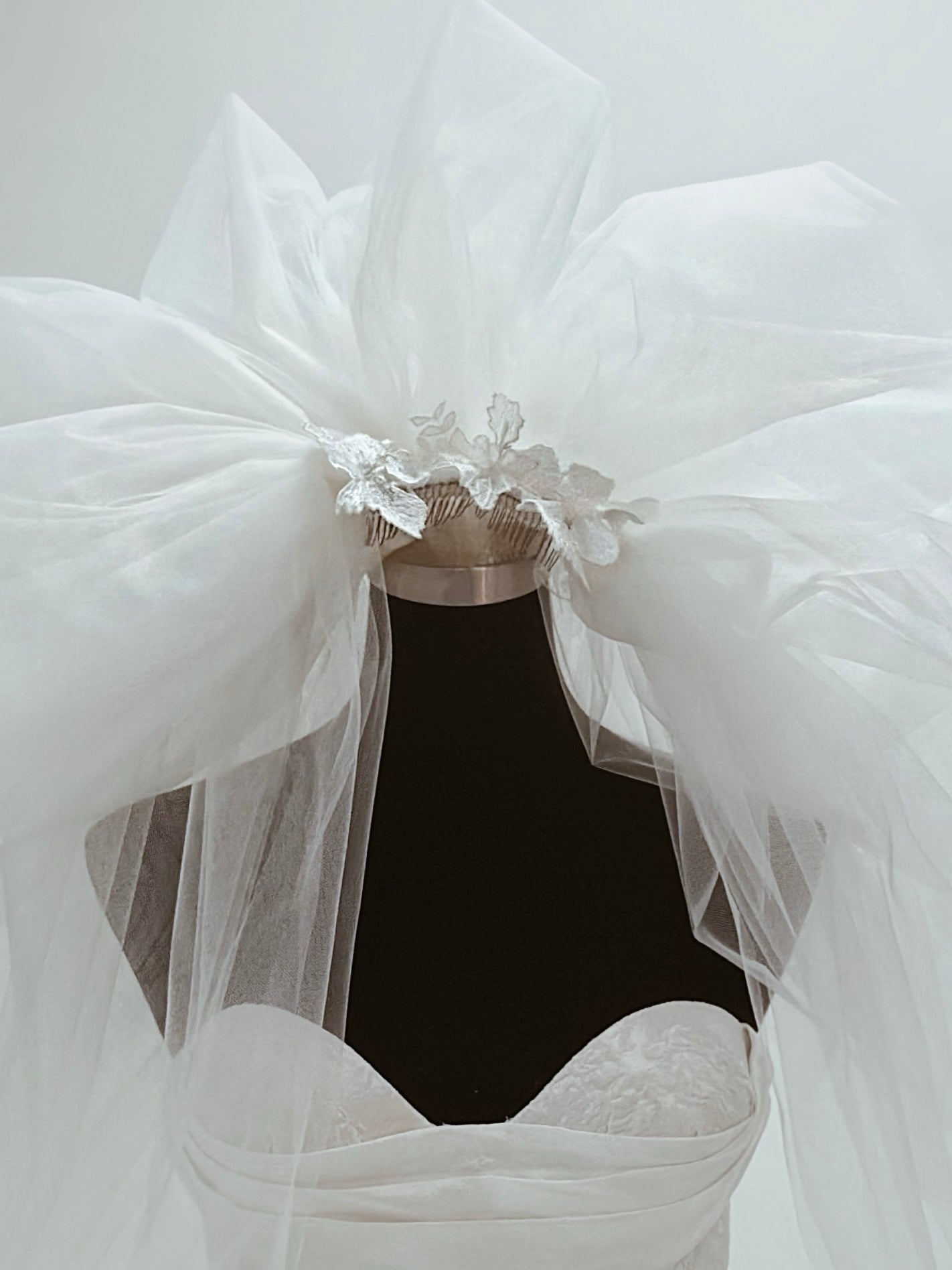 Detail image of lace appliques on the "Opus" tulle wedding veil by Lauren Elaine.