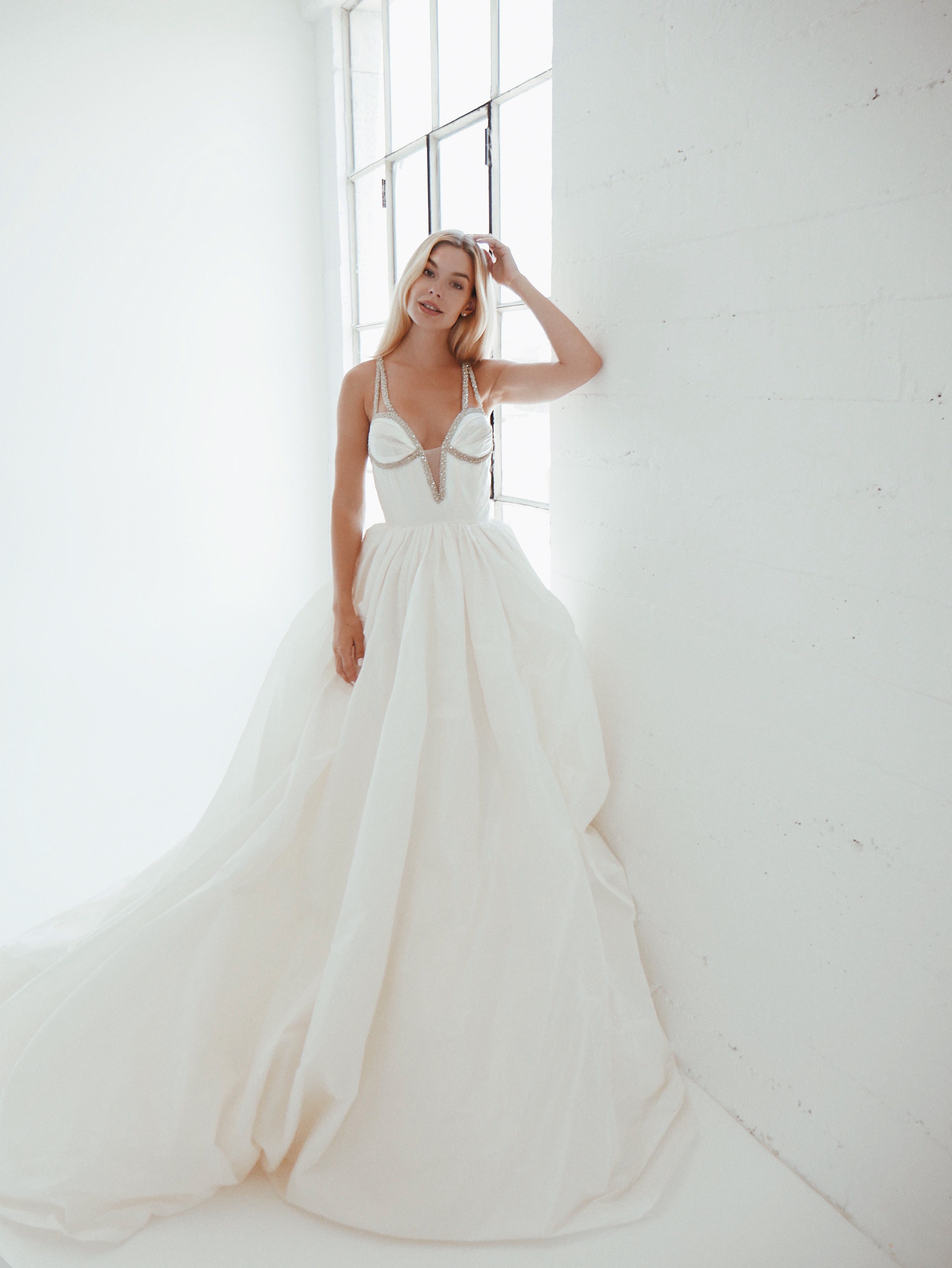 A model wears a timeless silk taffeta corset ball gown wedding dress by Lauren Elaine