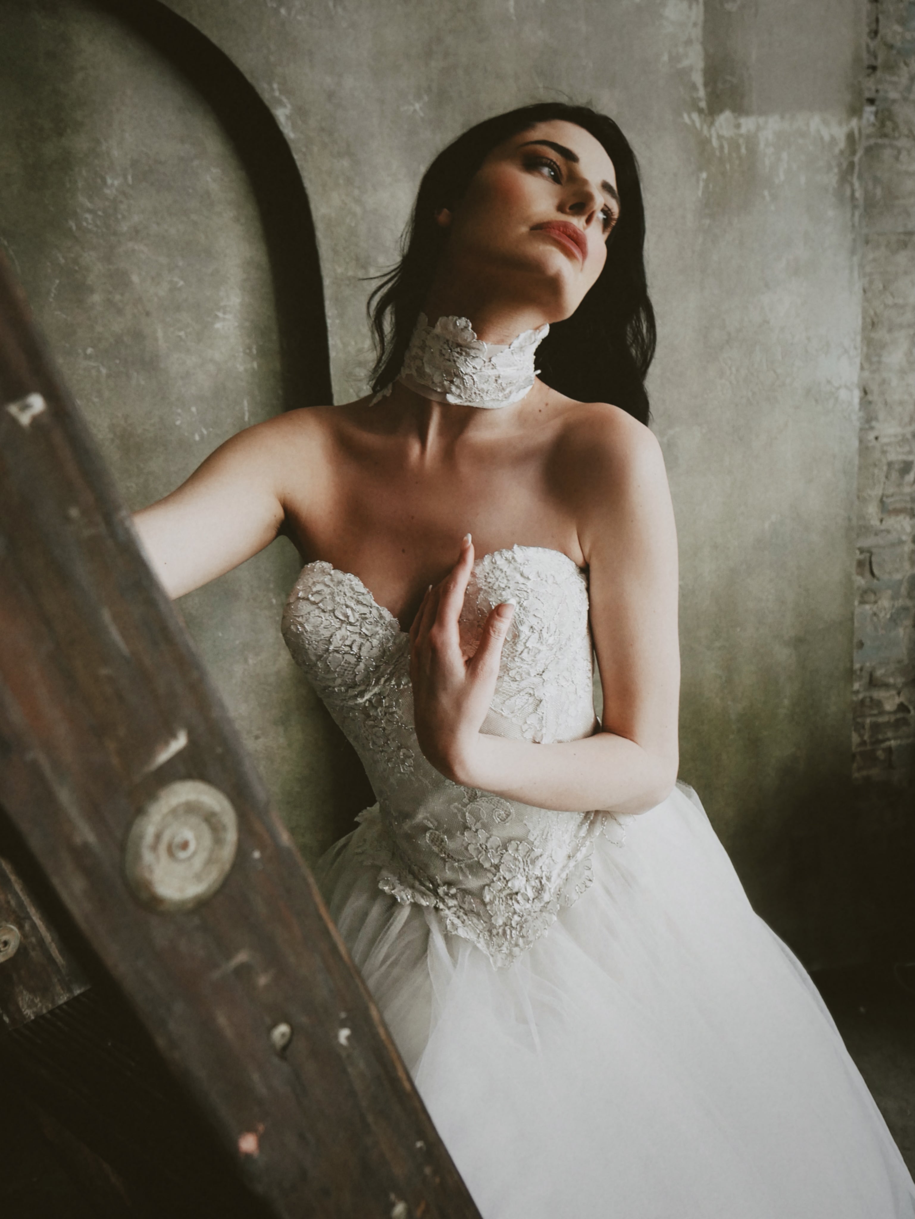 A model poses on a ladder in a photo studio Chantilly Lace Bridal Choker by Lauren Elaine.