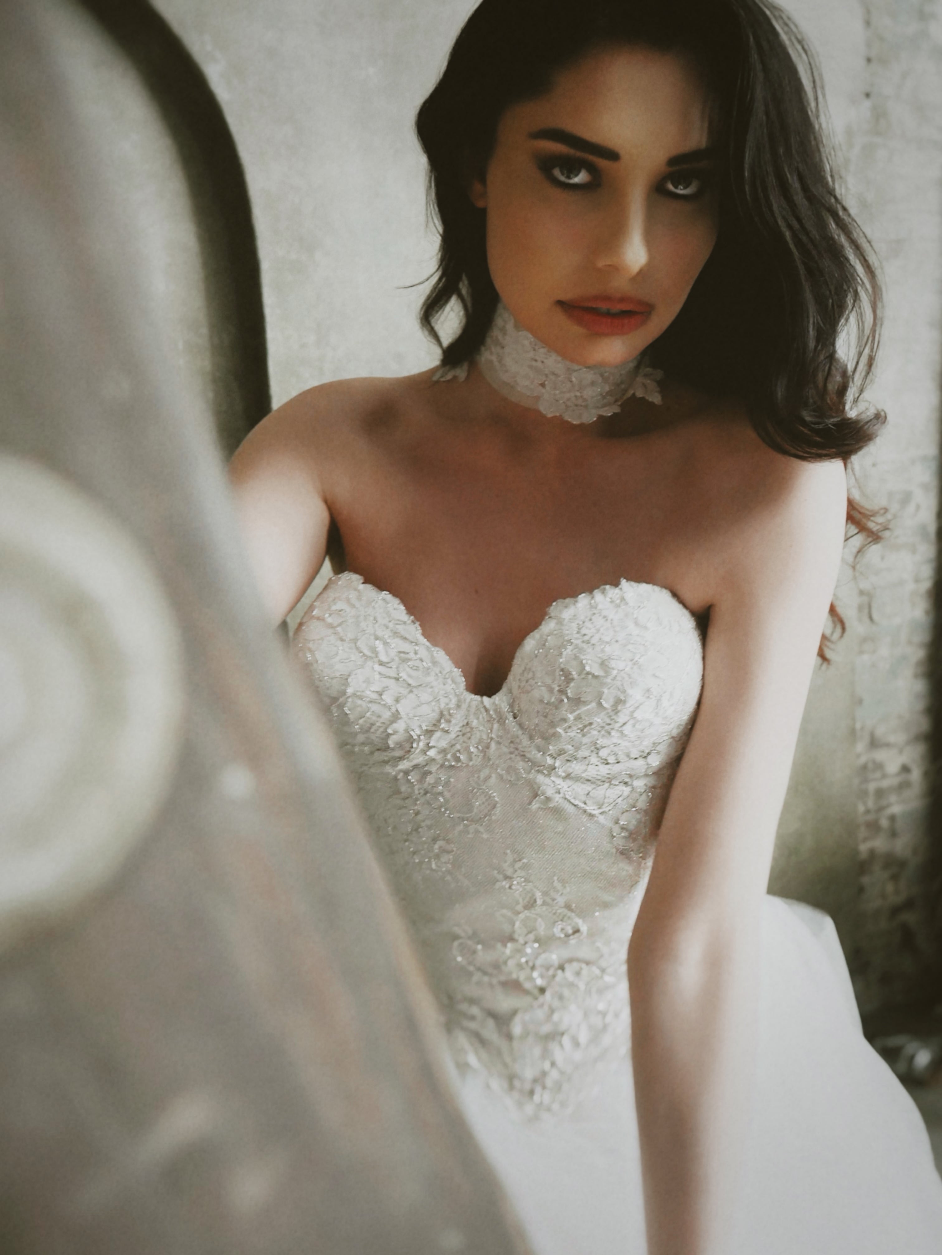 Closeup of model posing on a ladder in a photo studio Chantilly Lace Bridal Choker by Lauren Elaine.