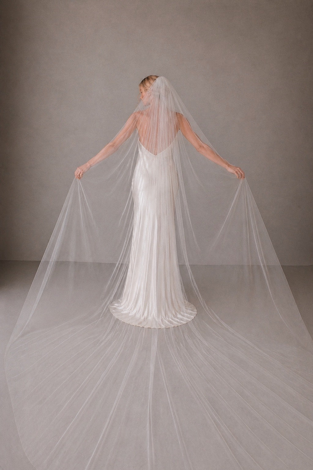 off white classic tulle wedding veil full width cathedral length raw edge bridal veil back view
