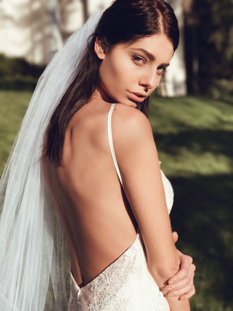 Blush backless mermaid trumpet form fit wedding gown of lace and tulle