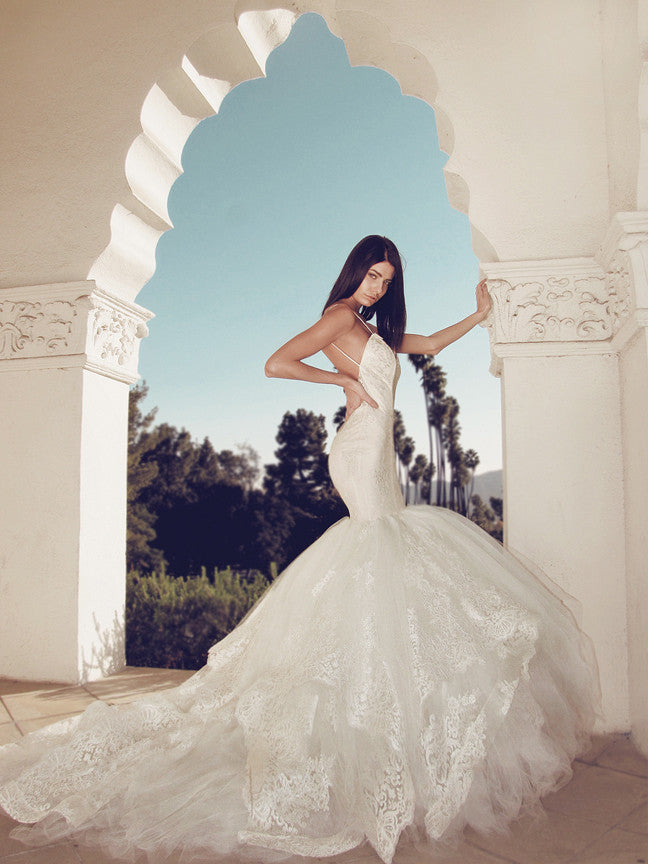 Sexy backless lace mermaid wedding gown with lace horsehair petals and cathedral train and spaghetti straps.