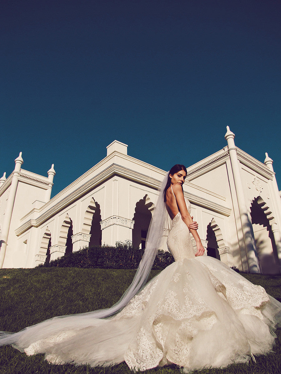 Dramatic mermaid wedding gown with lace and tulle cathedral train and cathedral veil.