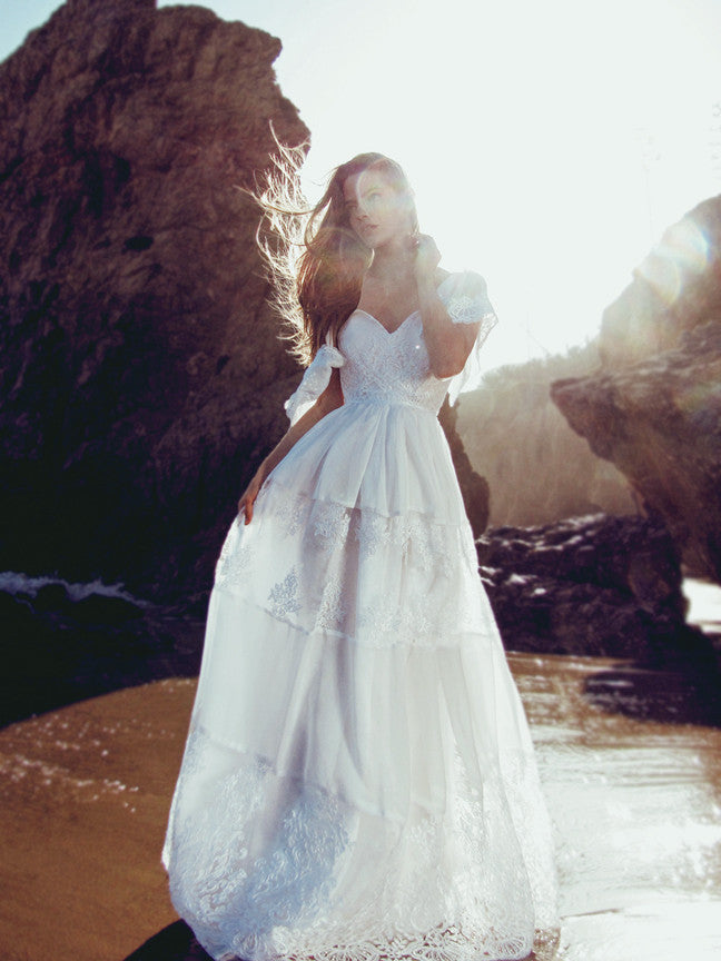 Lace A-line bridal gown with illusion back and tiered scalloped lace skirt