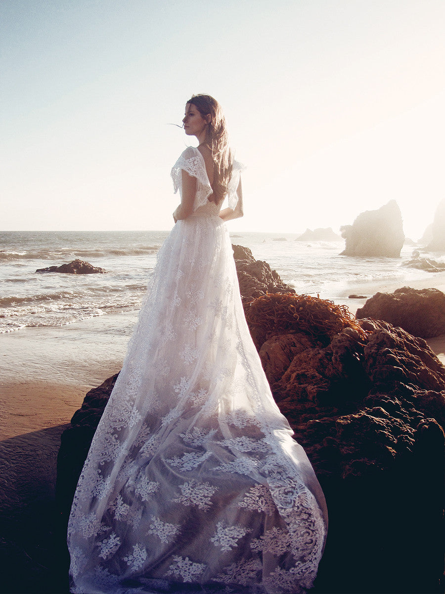 Capped sleeve lace wedding gown with detachable cathedral lace train