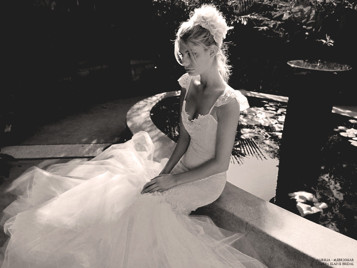 Vintage lace and tulle mermaid wedding gown with lace cap sleeves and embroidery.