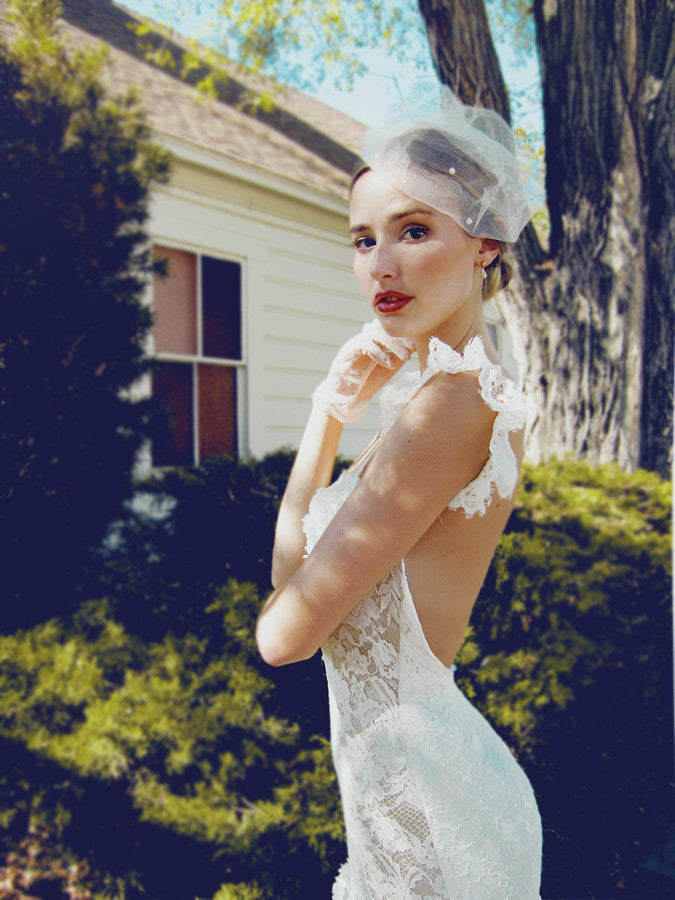 Romantic lace mermaid wedding gown with ruffle sleeves.