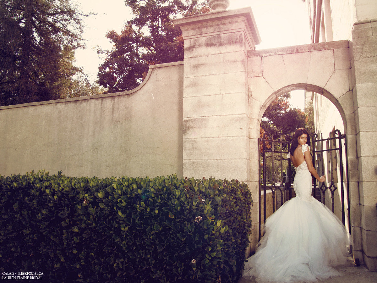 Backless mermaid wedding gown with cathedral tulle train in blush color