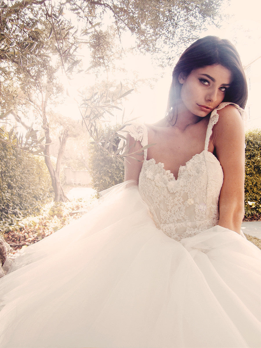 Romantic ethereal mermaid wedding gown with lace ruffle sleeves and flowers