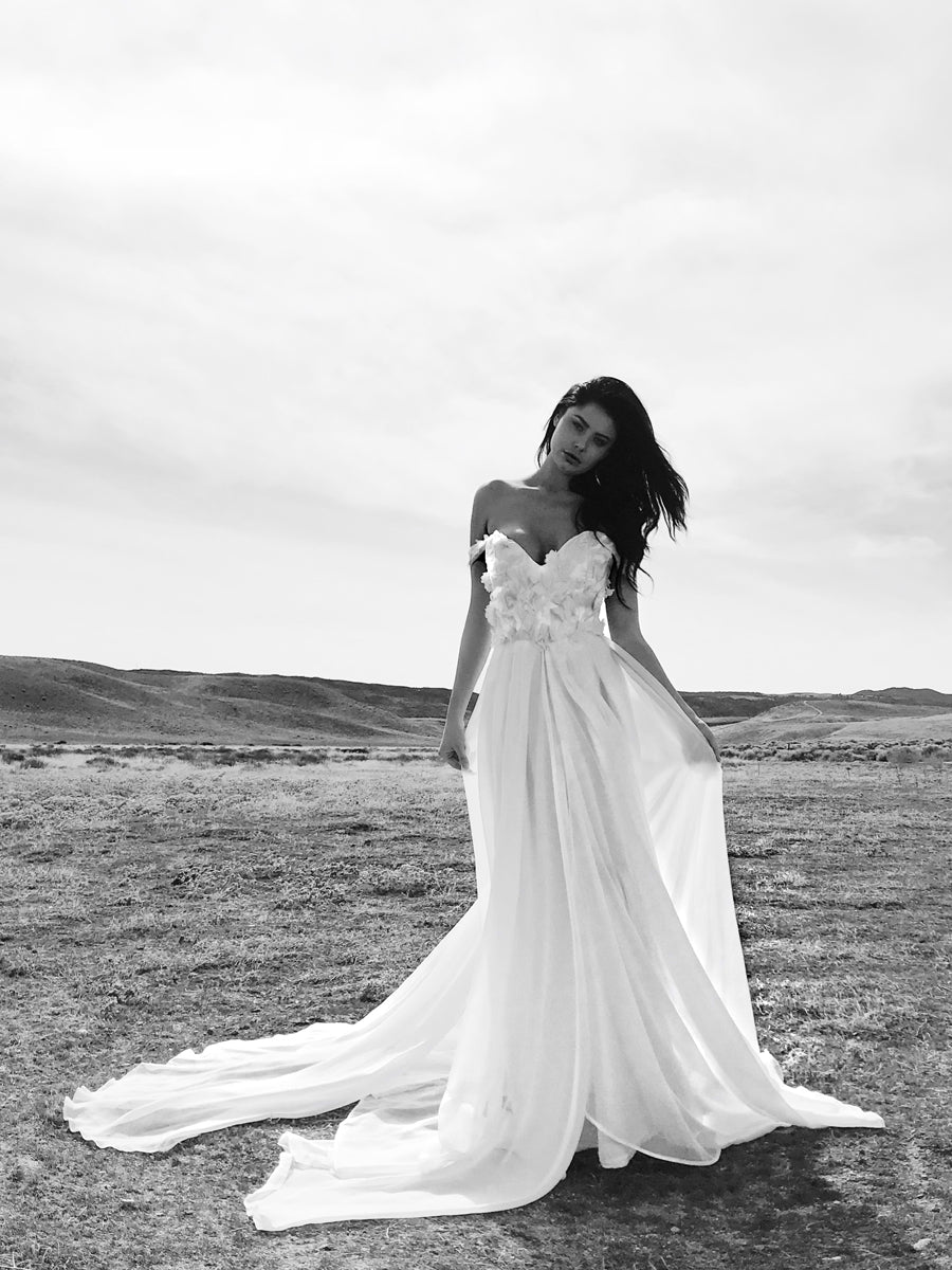 Romantic off-the-shoulder strapless sweetheart wedding dress with 3D lace floral appliques and chiffon skirt with cathedral train. Chrysalin from Lauren Elaine Bridal.