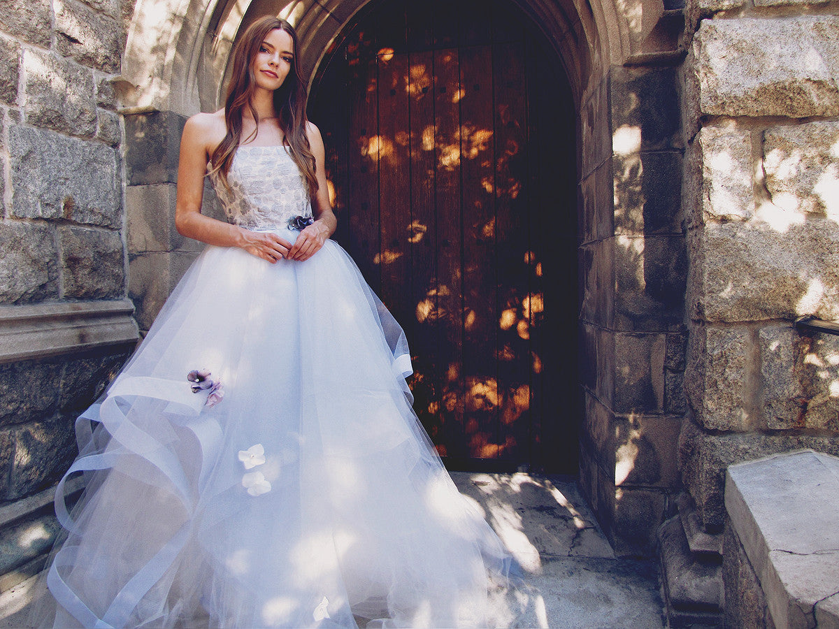 Lauren Elaine "Fleur" wedding gown with blue tulle skirt and horsehair petals. Crystal and pearl beading and flowers on skirt.