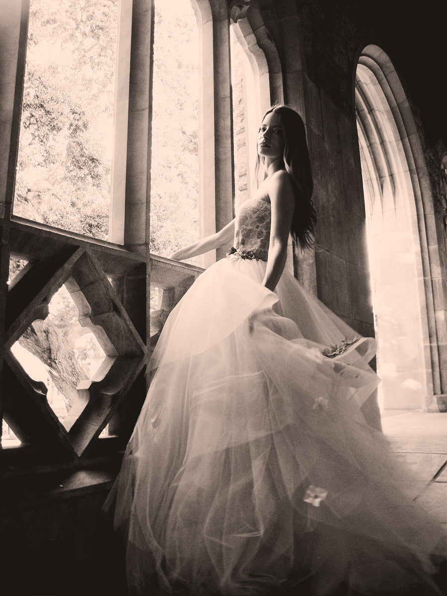 Princess ball gown wedding dress by Lauren Elaine with layers of tulle, horsehair petals, and 3D flowers on skirt dusted with crystals and pearls.