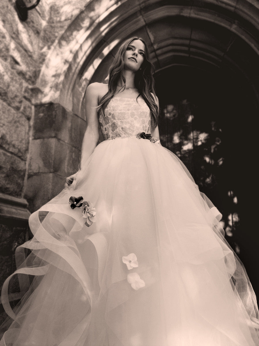 Fleur wedding gown by Lauren Elaine with flower appliqués and horsehair petals with metallic brocade bodice and crystal detailing.