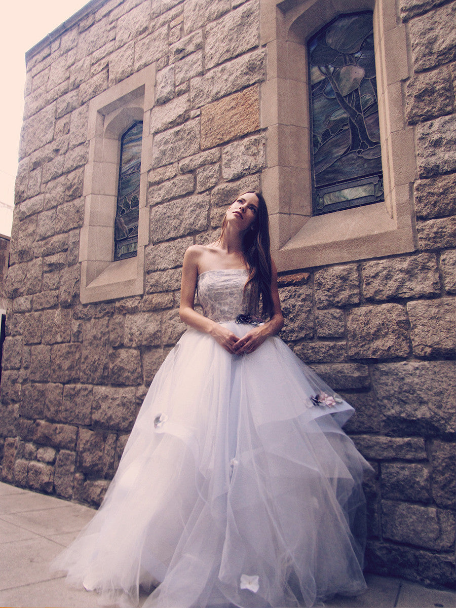 Unicorn wedding gown in pewter mist by Lauren Elaine Bridal with metallic blue brocade strapless bodice and rainbow flowers on skirt.