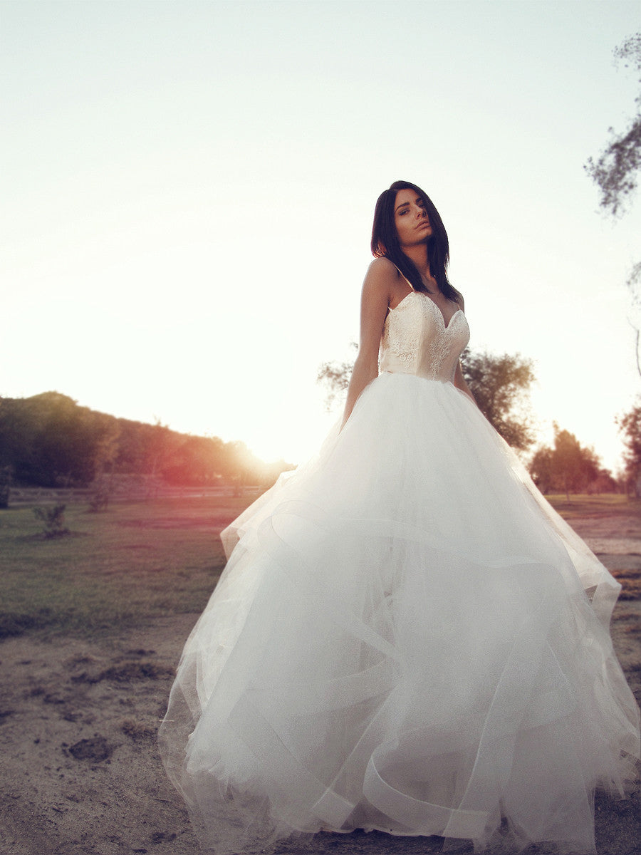 Classic tulle ball gown princess wedding dress with horsehair petals and sweetheart bodice.